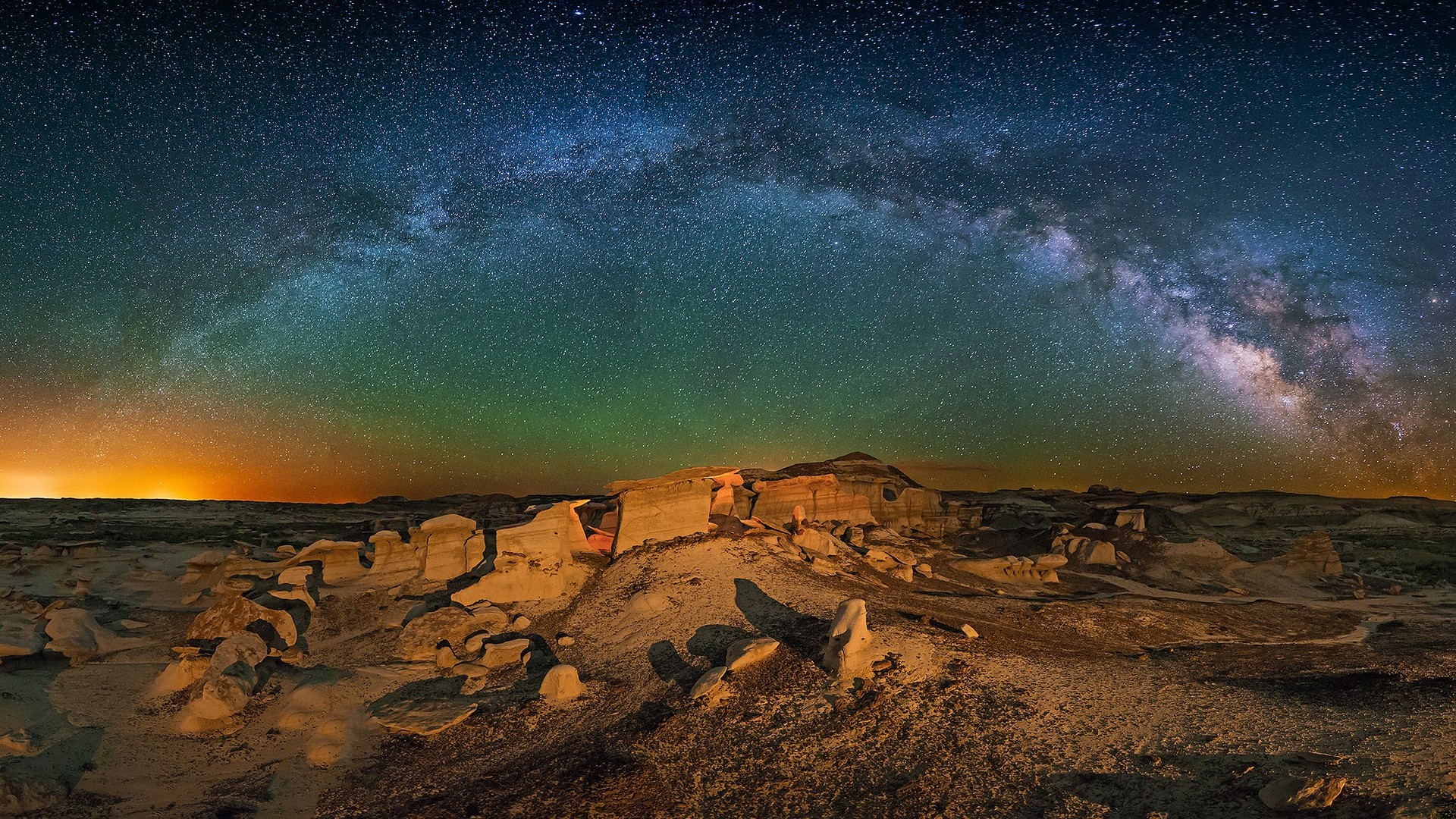 Milky Way over desert rock formations at night HD Wallpaper