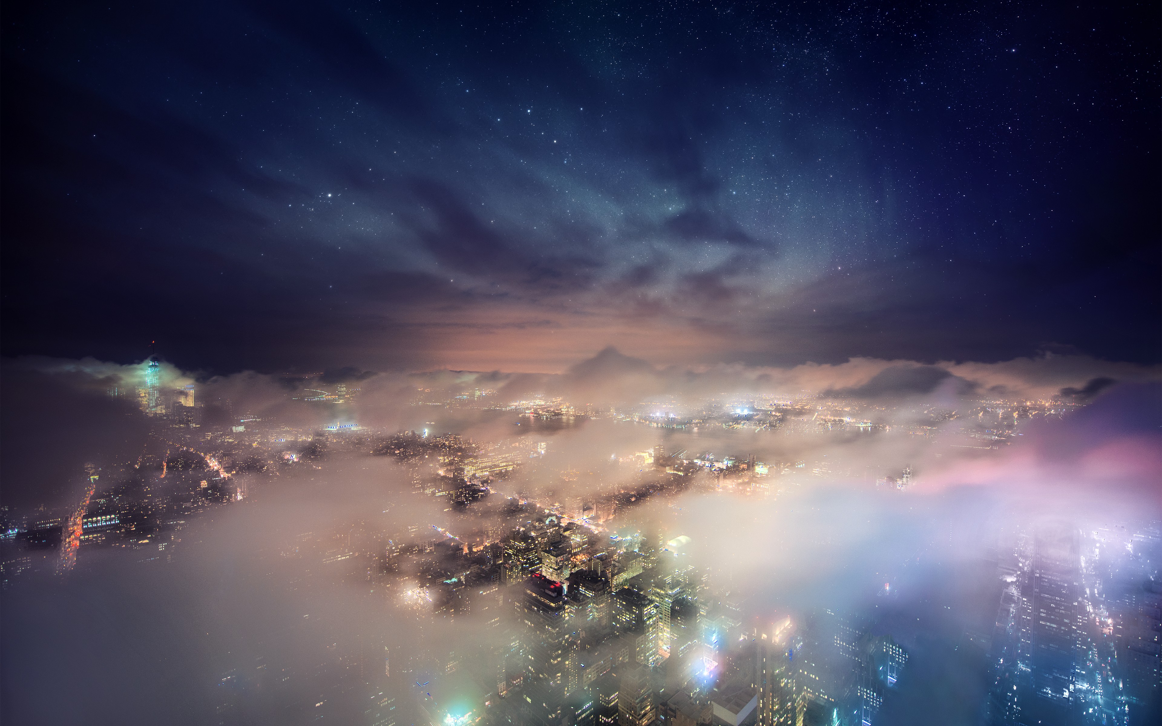 New York City cityscape shrouded in mist under a starry sky HD Wallpaper