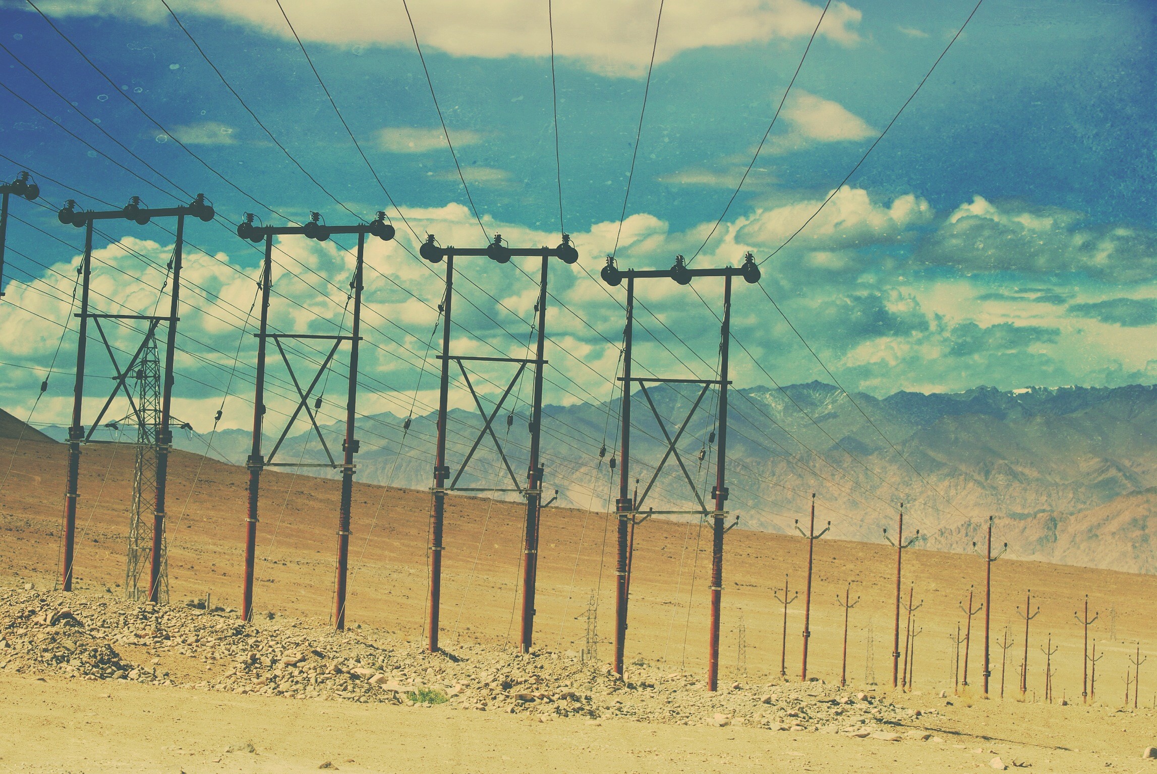 Desert landscape with power lines and mountains HD Wallpaper