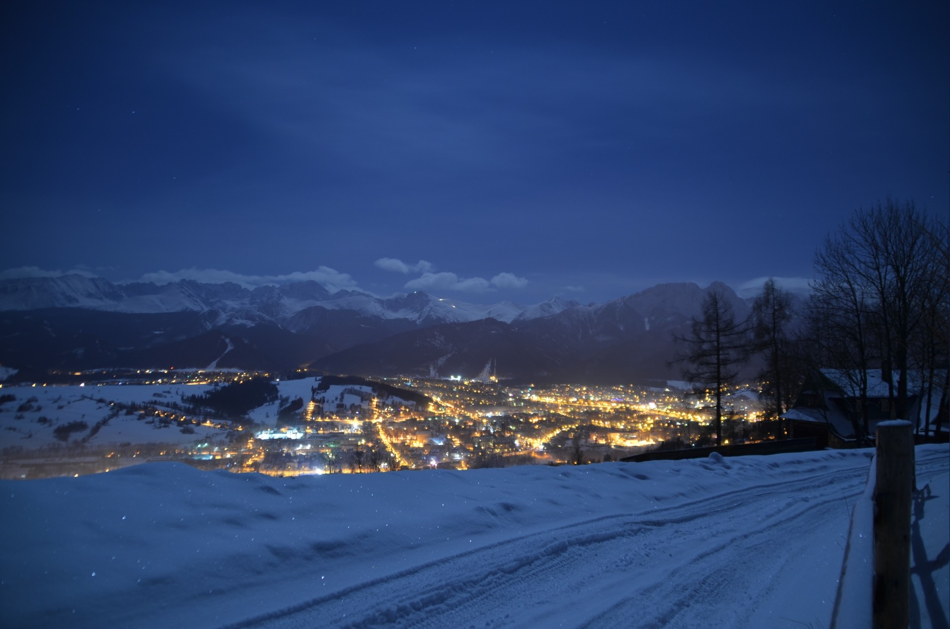 Snowy mountain town at night HD Wallpaper