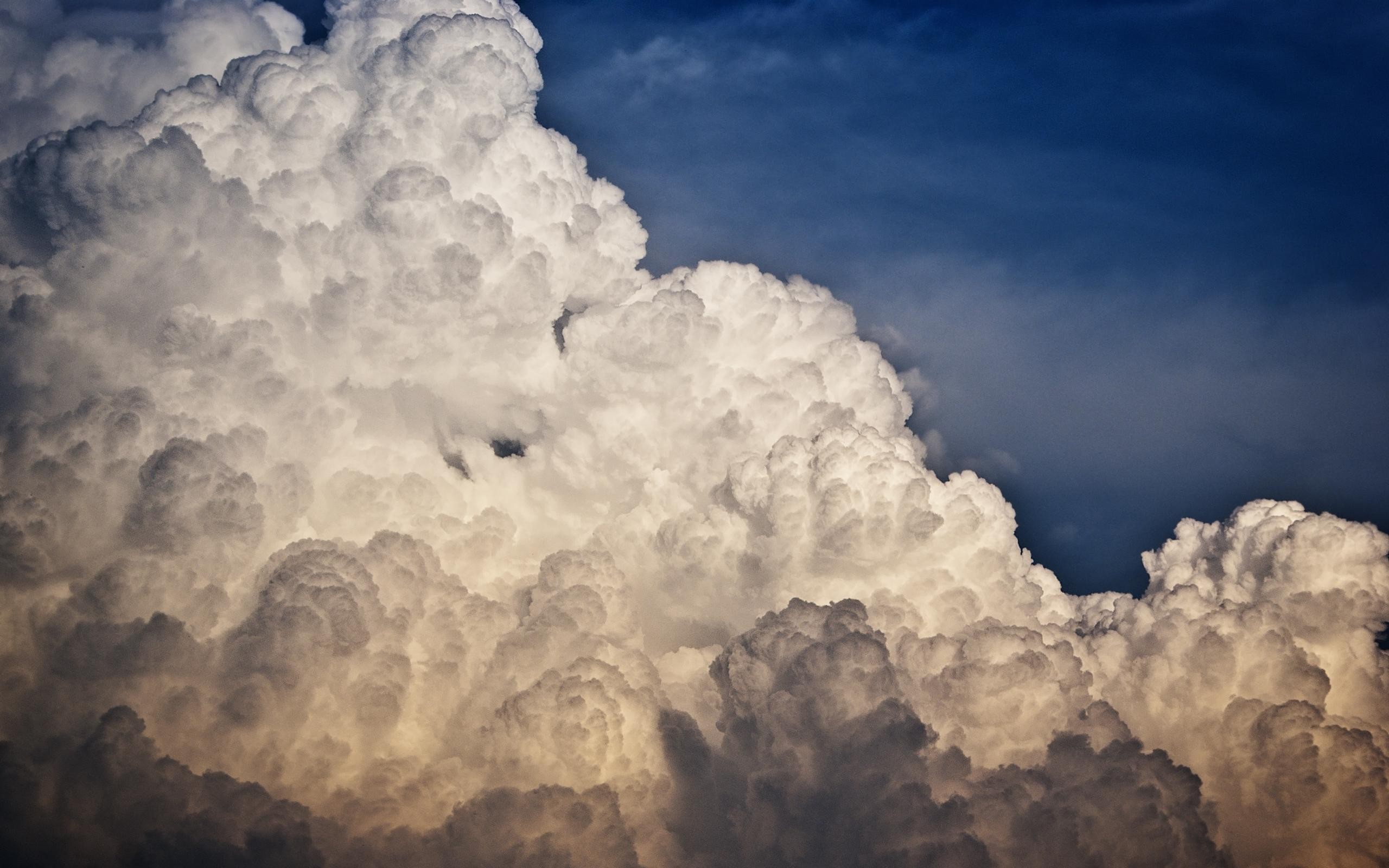 Cumulonimbus clouds against a dark blue sky HD Wallpaper