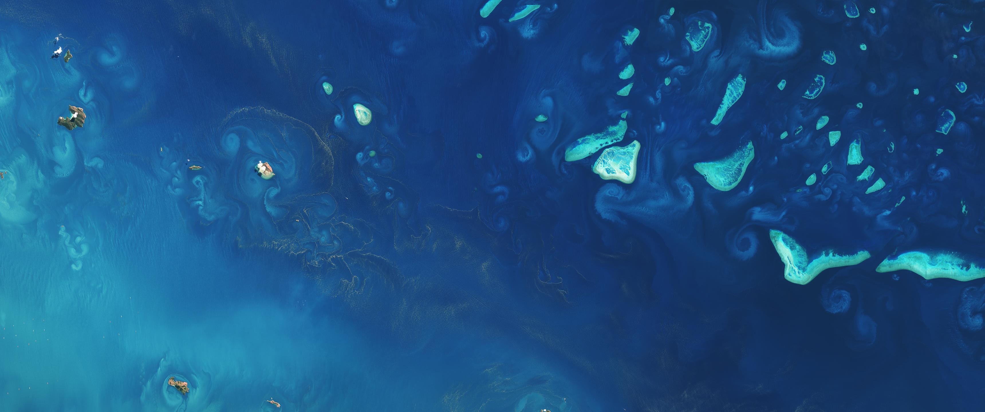 Aerial view of islands and ocean currents HD Wallpaper