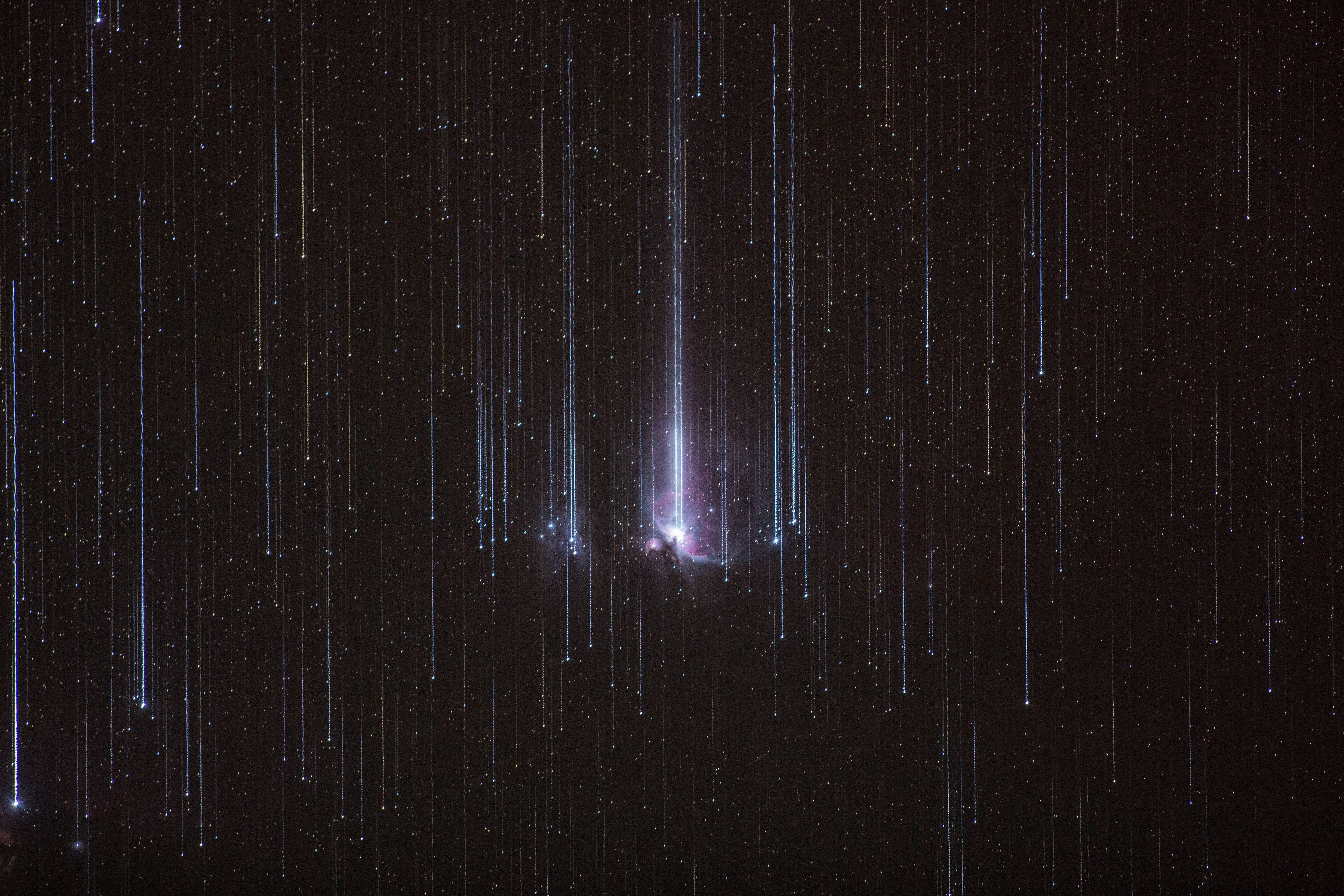 Digital art of a meteor shower over the Orion Nebula HD Wallpaper