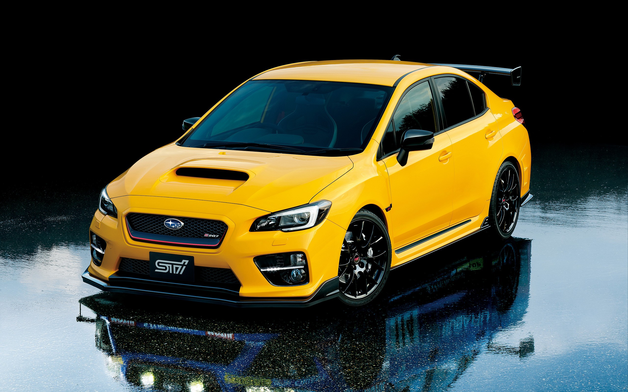 Yellow Subaru WRX STI with a large rear spoiler HD Wallpaper