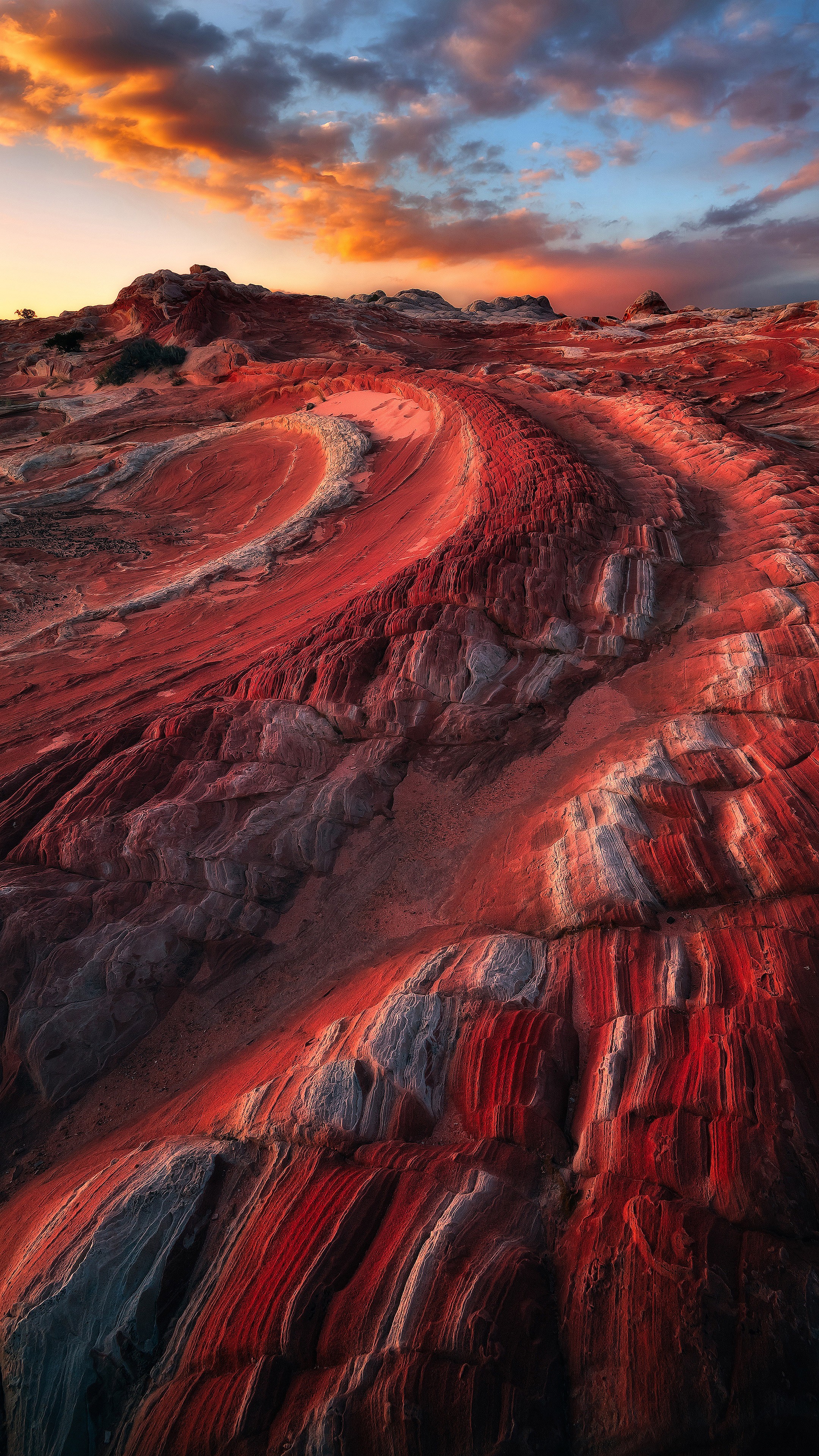 Red rock formations under a dramatic sunset sky HD Wallpaper