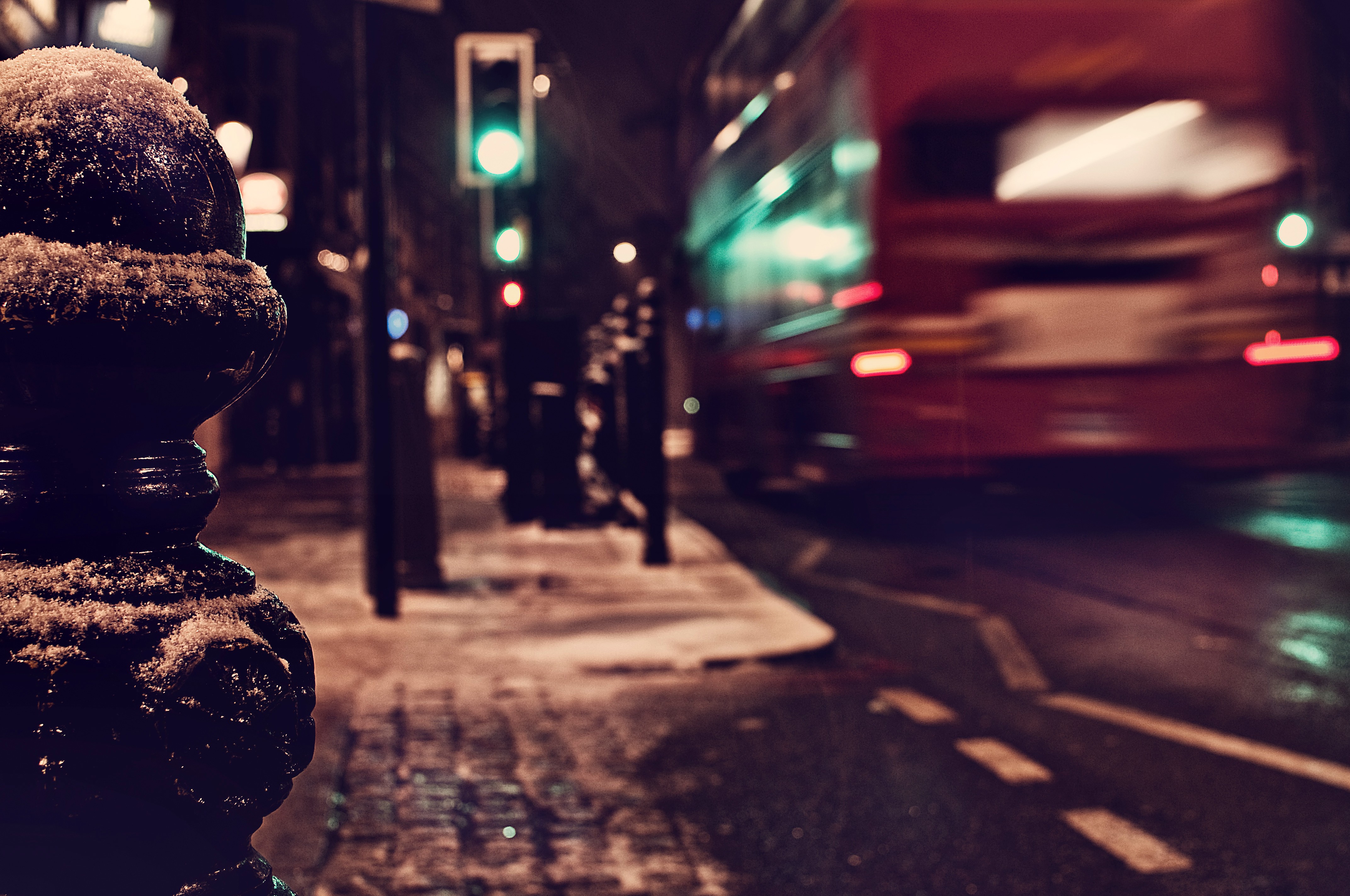 London street at night with a red bus in the snow HD Wallpaper
