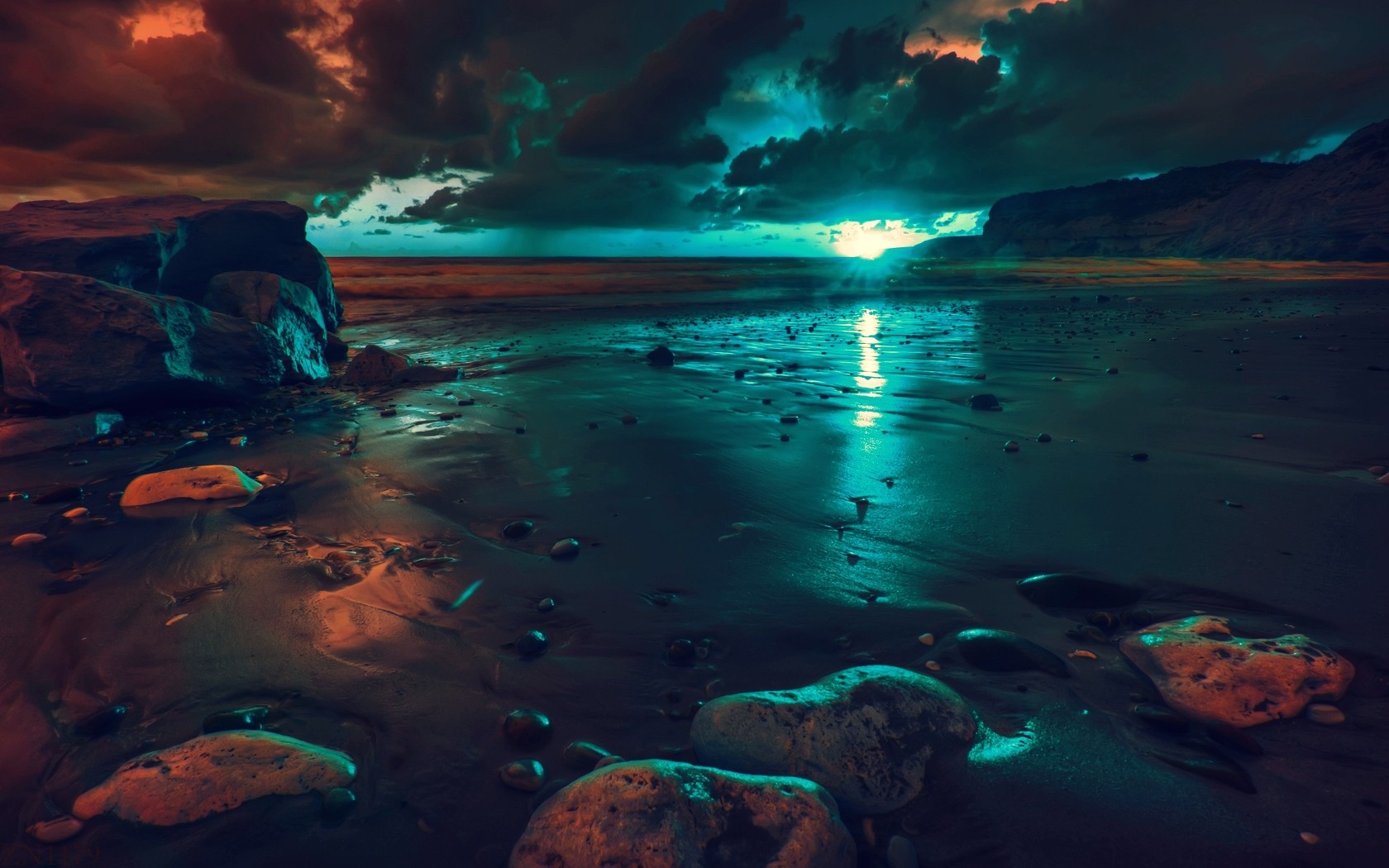 Beach with rocks and ocean under dramatic sky HD Wallpaper