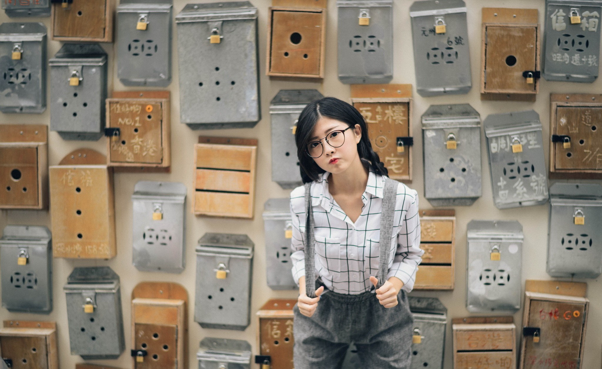 Asian woman posing in front of mailboxes HD Wallpaper
