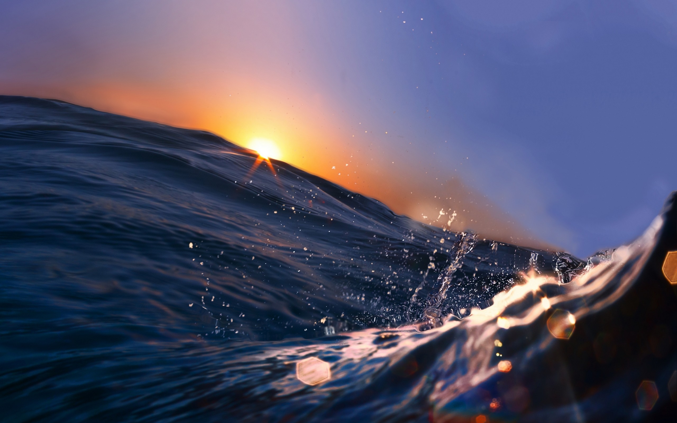 Sunset over ocean waves with lens flare HD Wallpaper