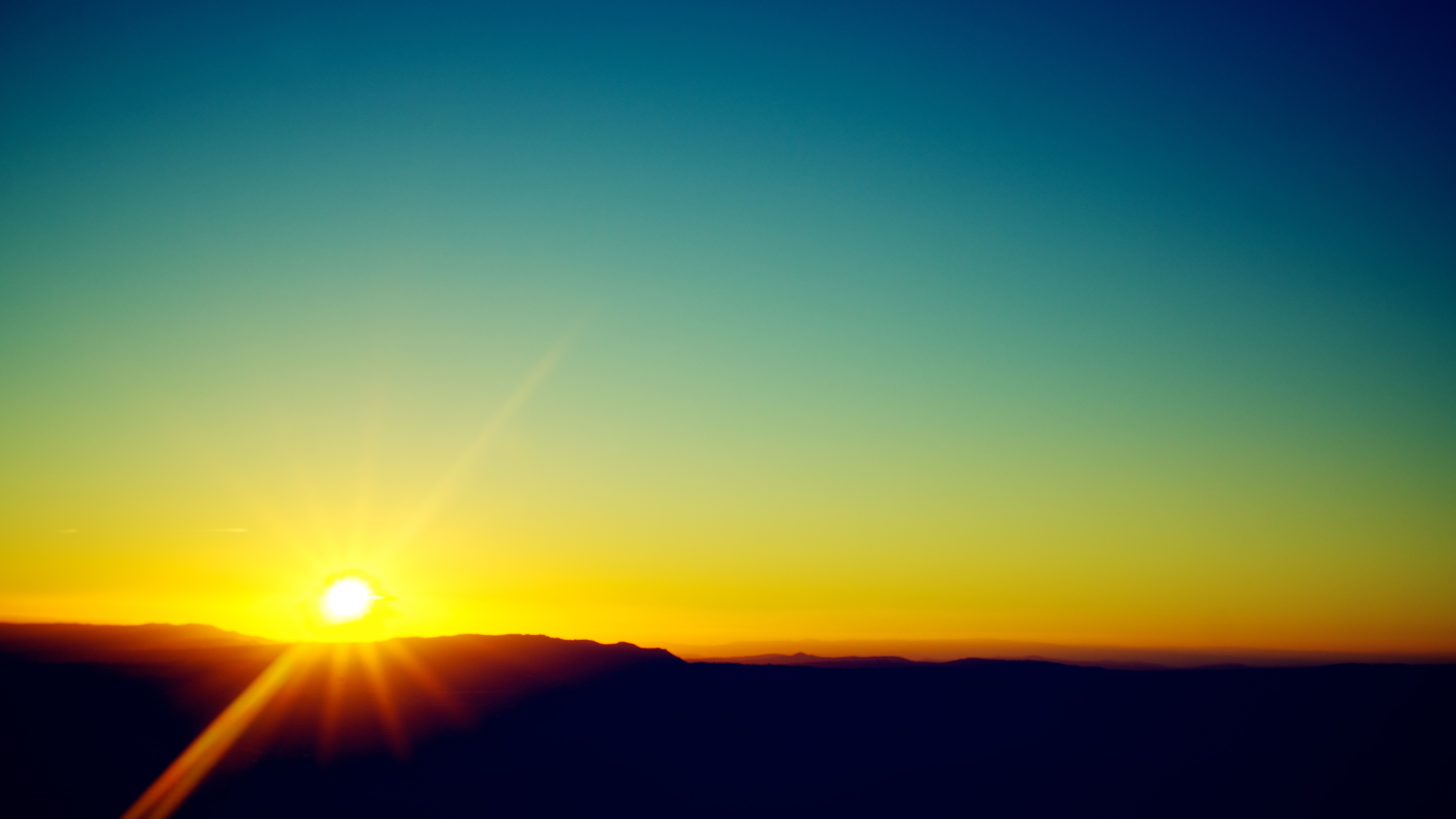 Sunset over a mountain range HD Wallpaper
