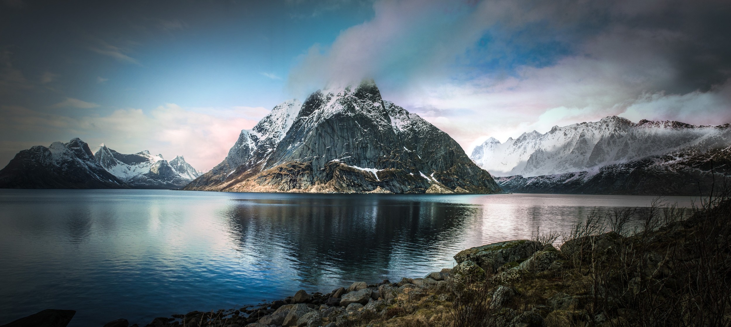 Snowy mountains reflected in a calm fjord in Norway HD Wallpaper