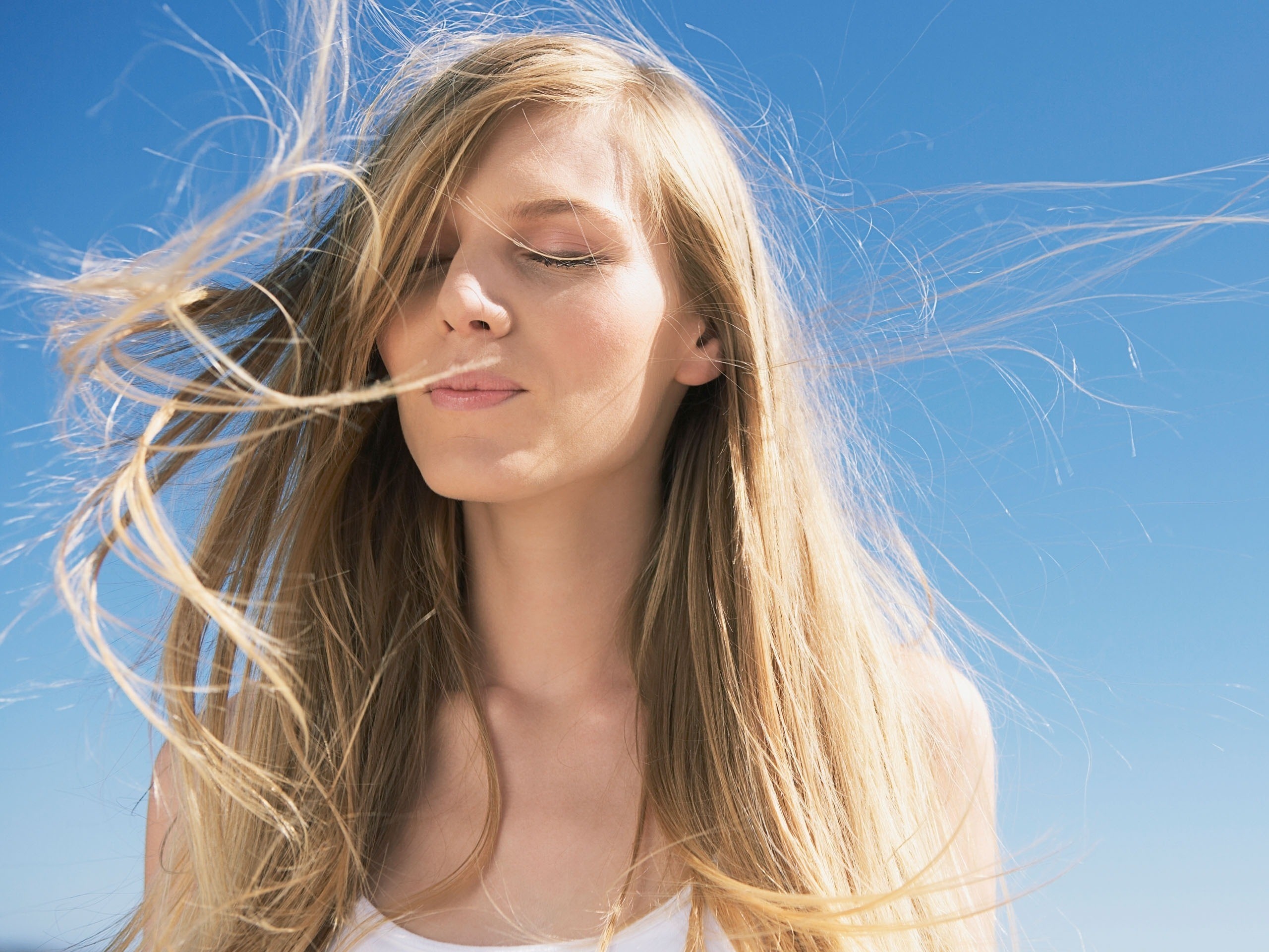 Woman with blonde hair blowing in the wind HD Wallpaper