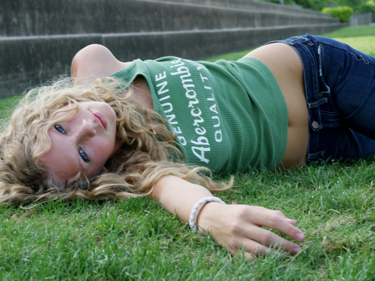 Abercrombie & Fitch tank top on a blonde woman lying on grass HD Wallpaper