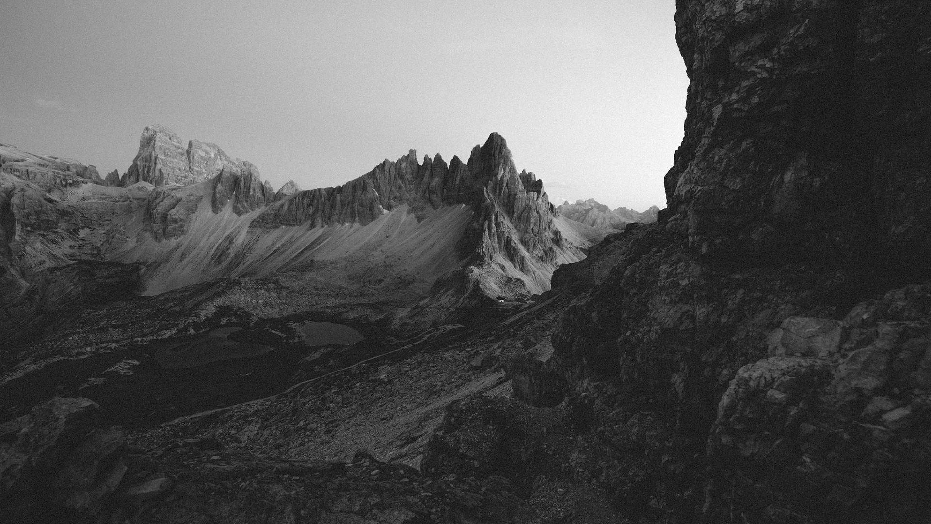 Jagged mountain peaks in a black and white landscape HD Wallpaper