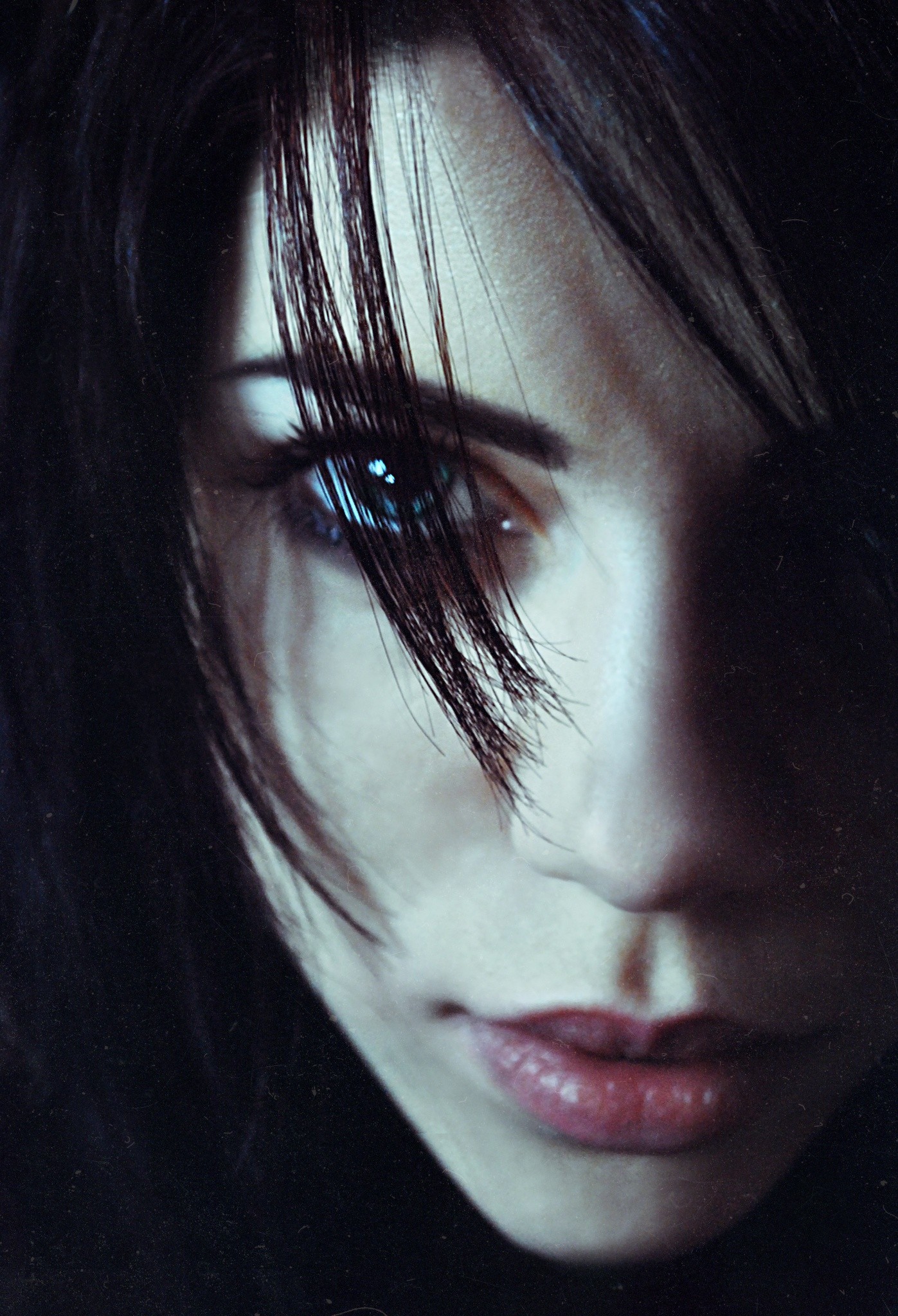 Close-up of a woman's face with dark hair HD Wallpaper