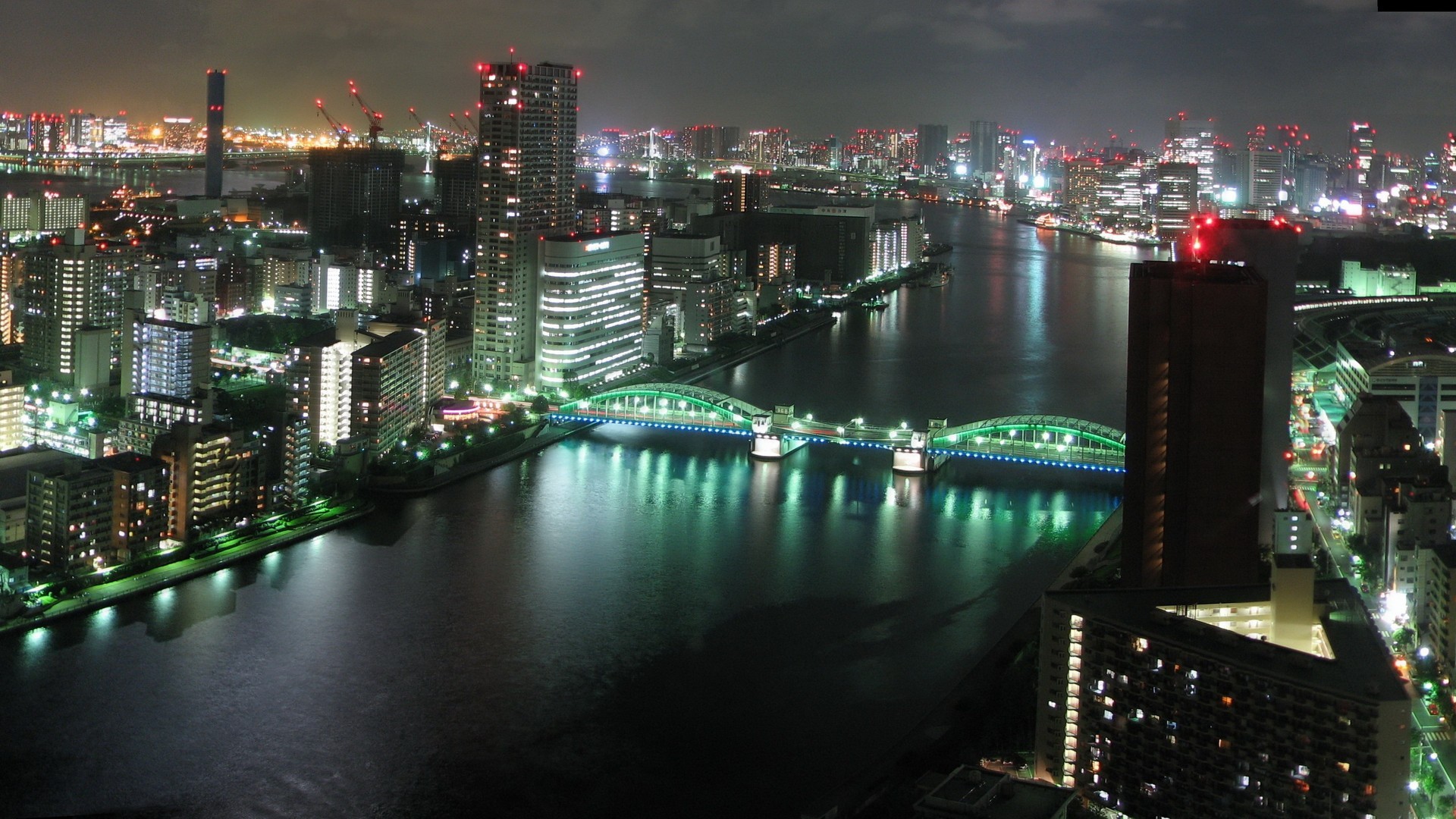 Tokyo cityscape at night with a river and bridge HD Wallpaper
