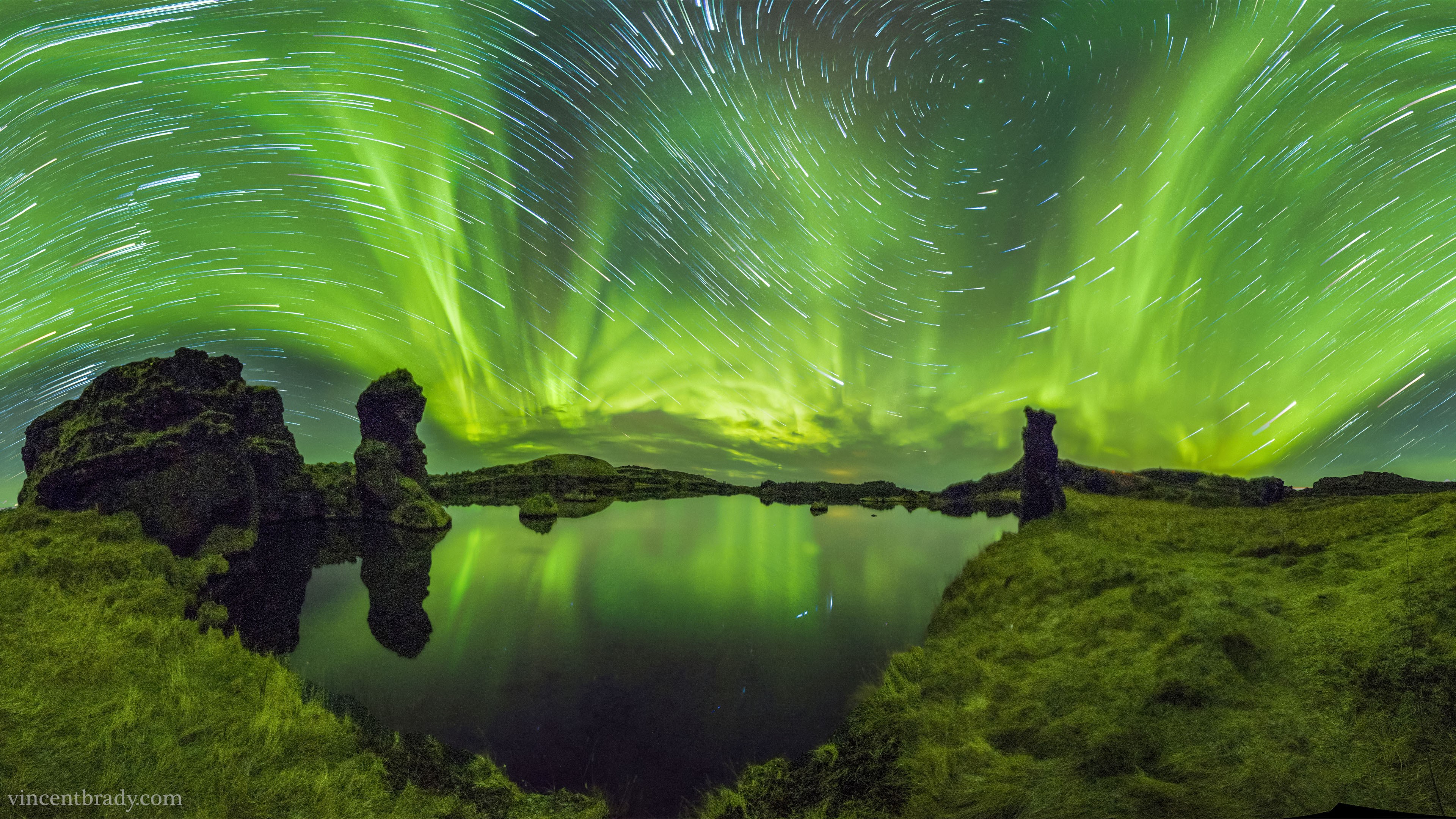 Aurora Borealis over a lake with star trails HD Wallpaper