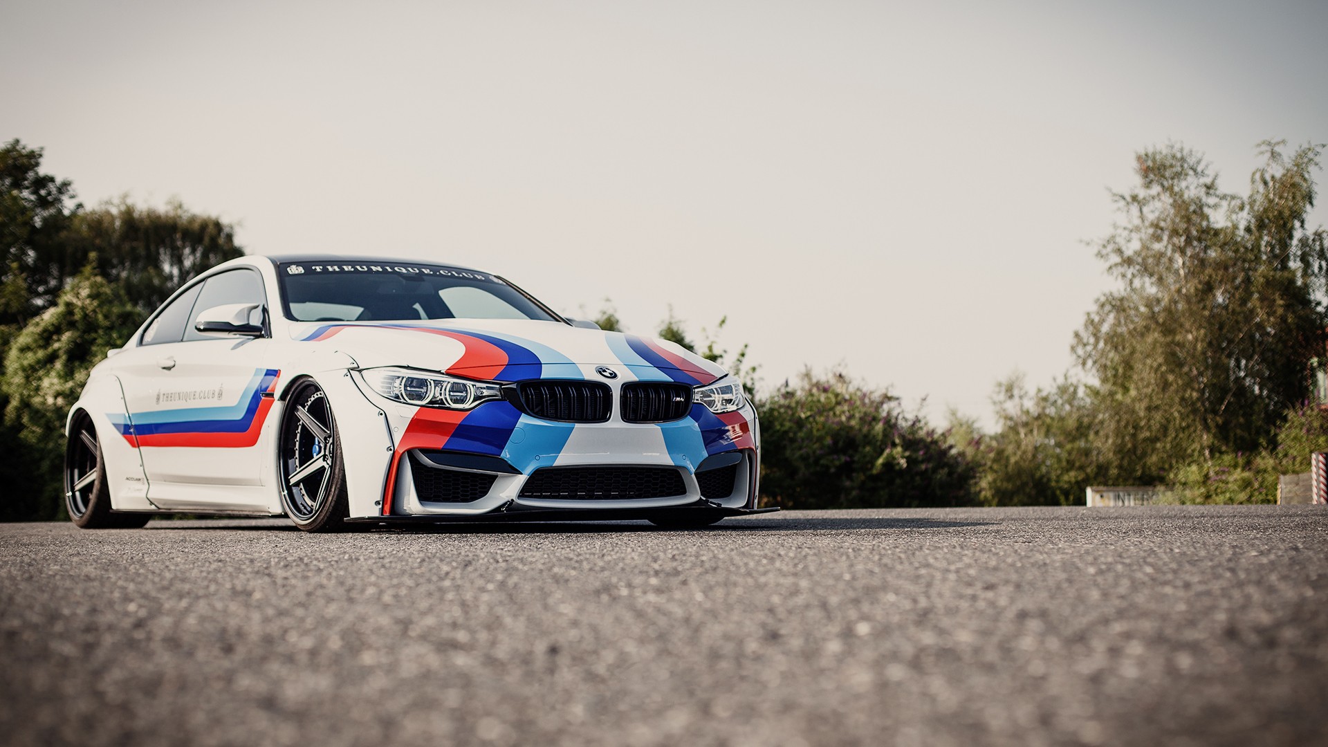 White BMW M4 with racing stripes HD Wallpaper