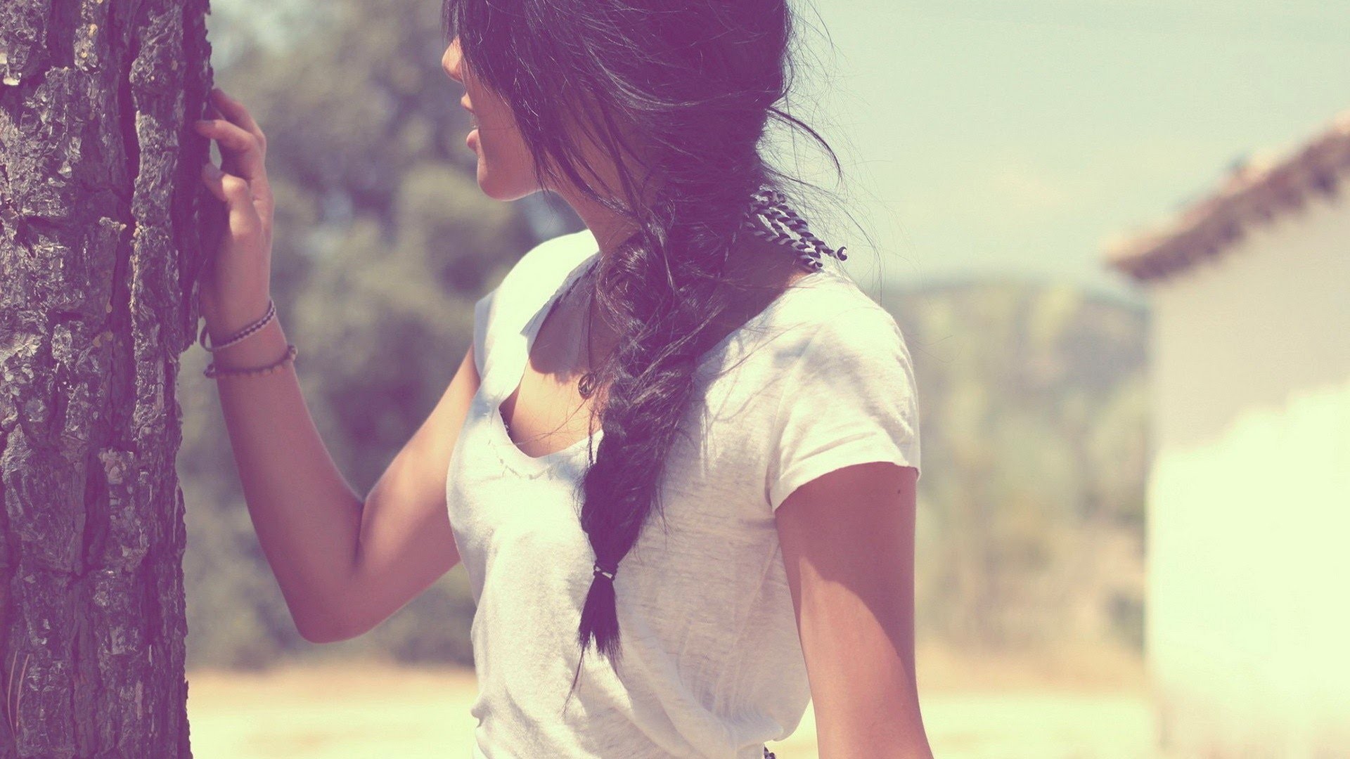 Woman with long braid leaning on a tree HD Wallpaper