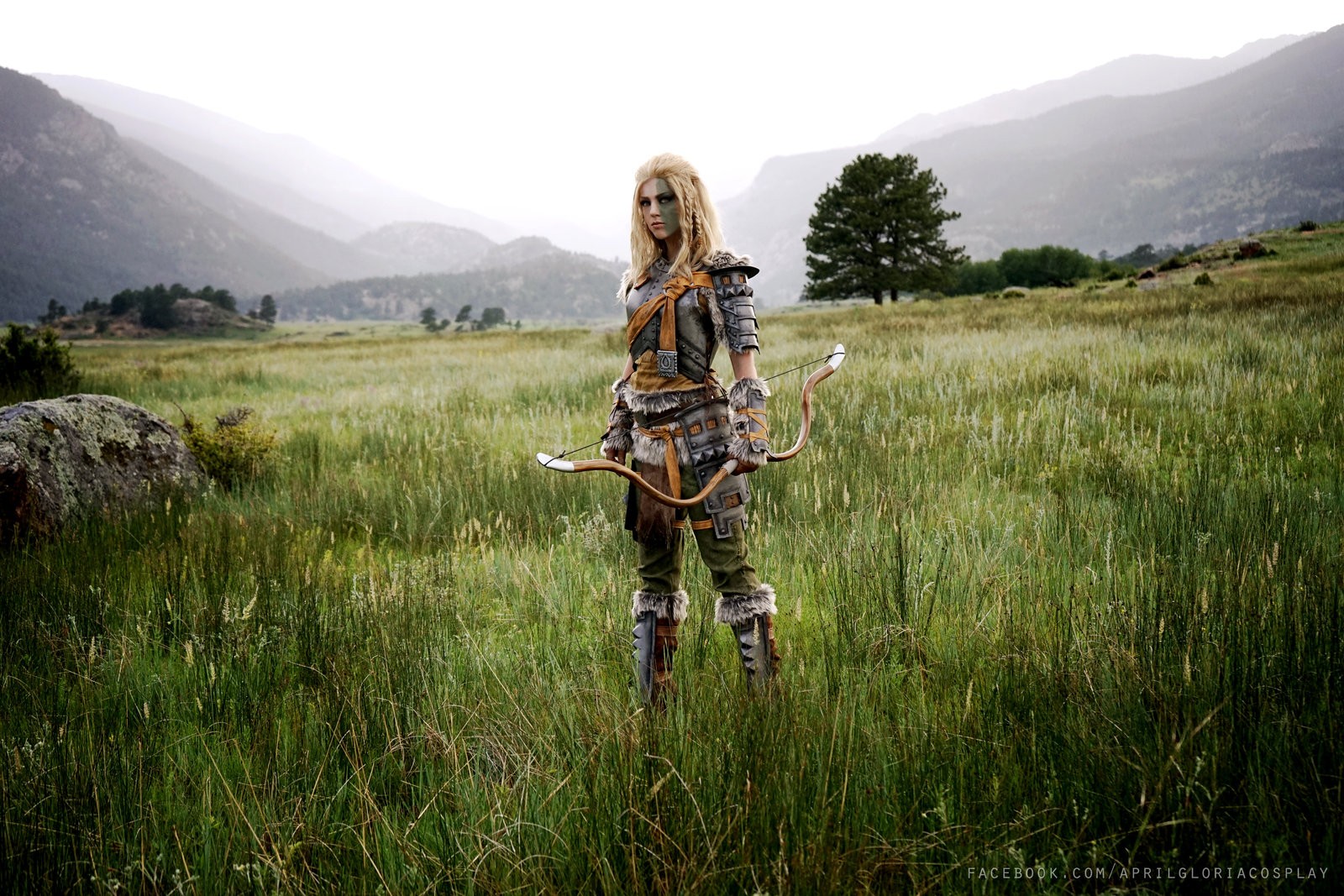 Cosplayer dressed as Skyrim character with bow in field HD Wallpaper