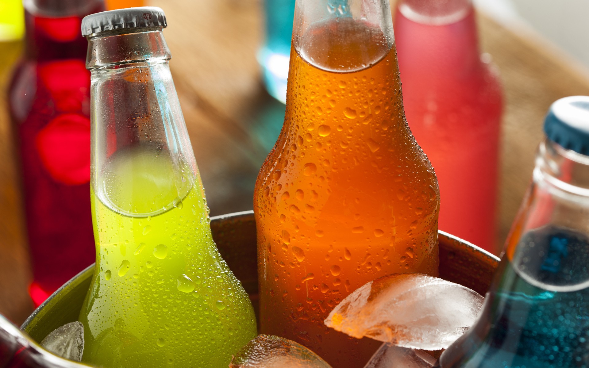 Assorted colorful soda bottles in ice HD Wallpaper