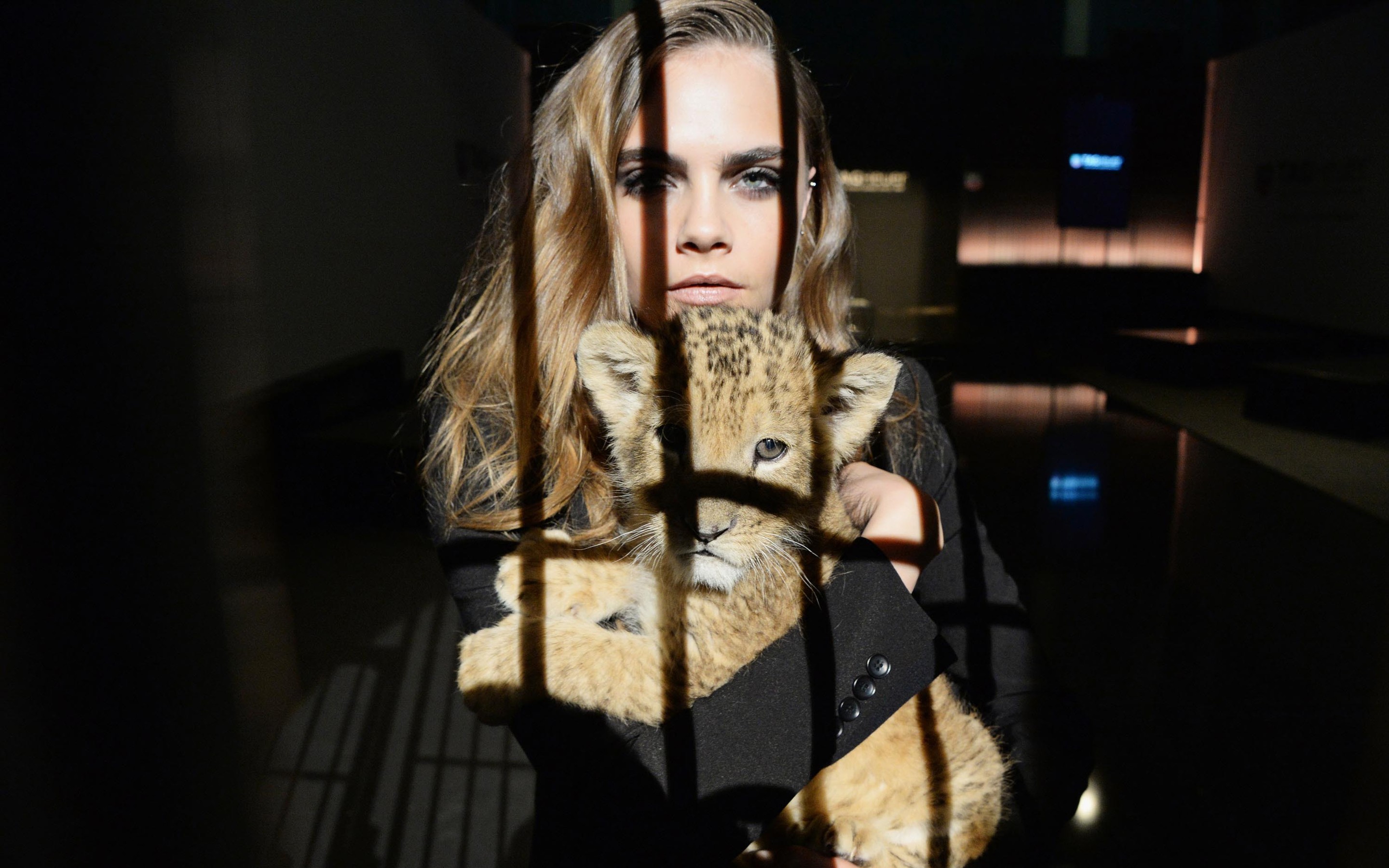 Cara Delevingne holding a baby lion HD Wallpaper