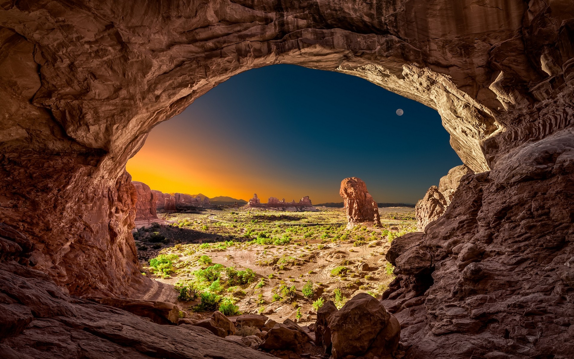 View from a cave at Arches National Park during sunrise HD Wallpaper