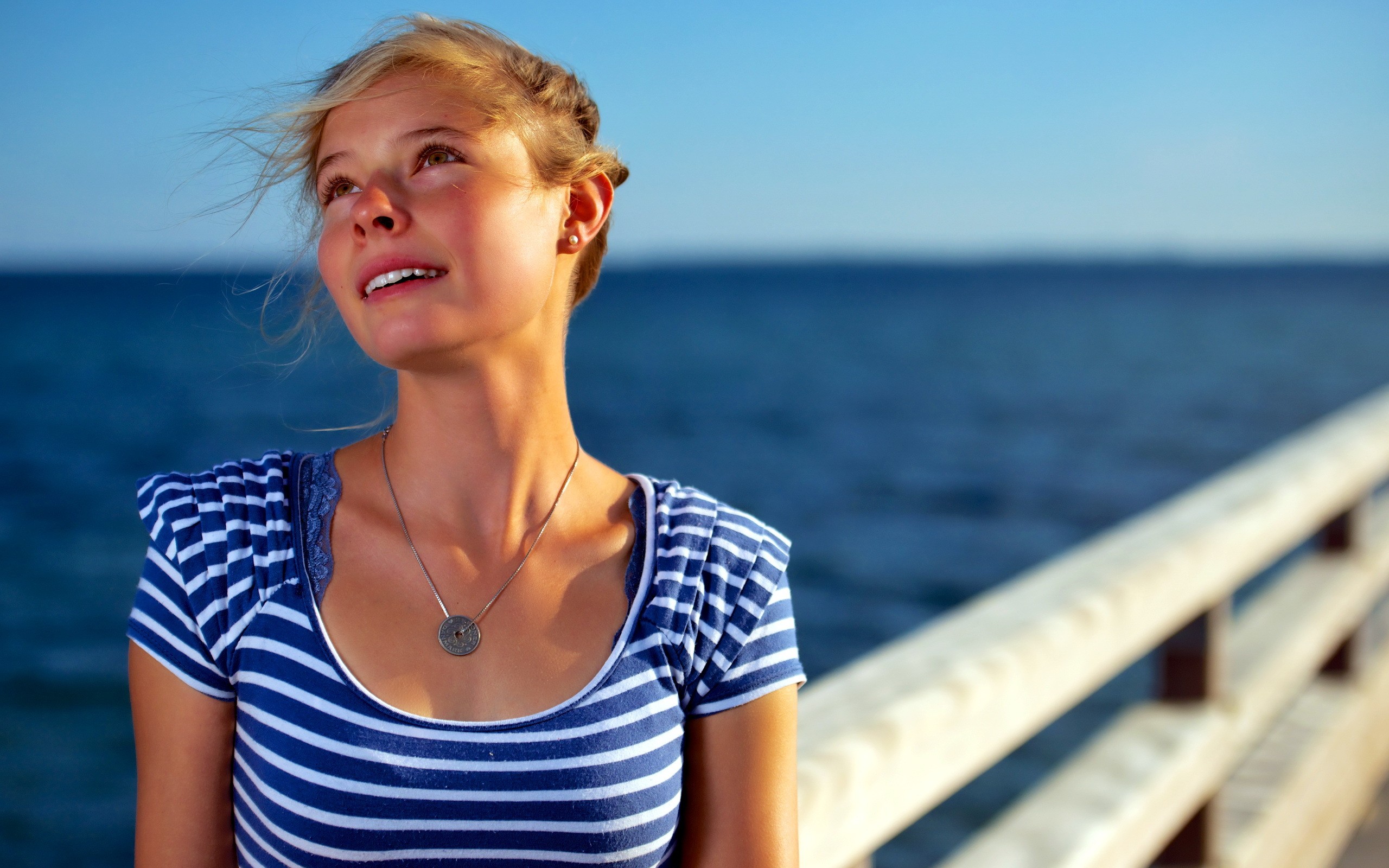 Young woman on a pier by the sea HD Wallpaper