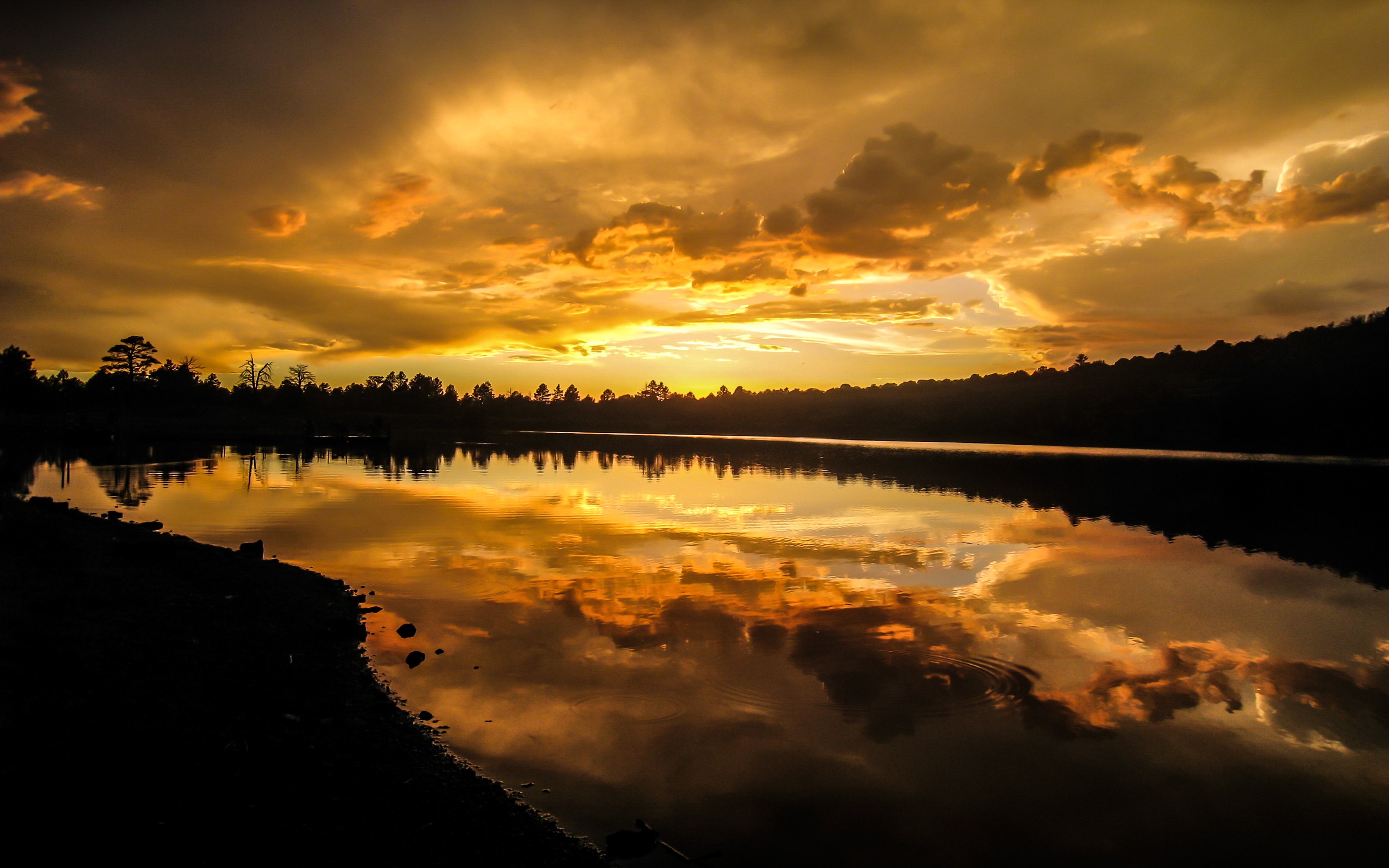 Sunset over a lake with dramatic clouds HD Wallpaper
