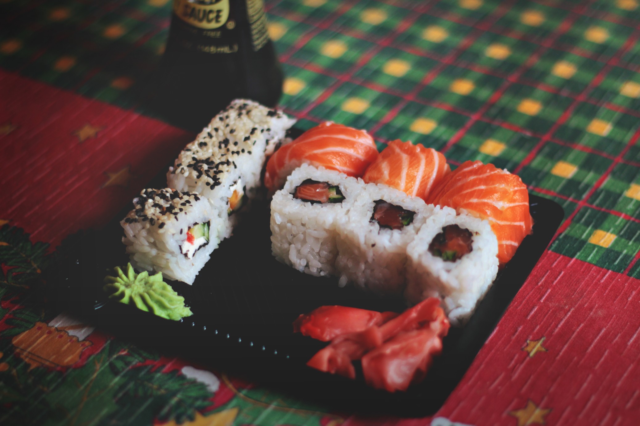 Sushi and soy sauce bottle on a table HD Wallpaper