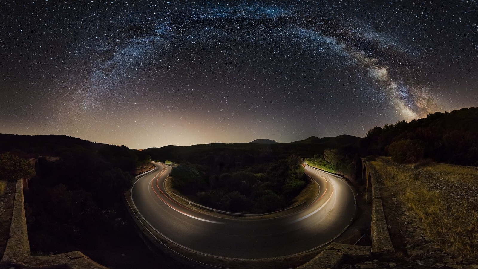 Milky Way over a winding road at night HD Wallpaper