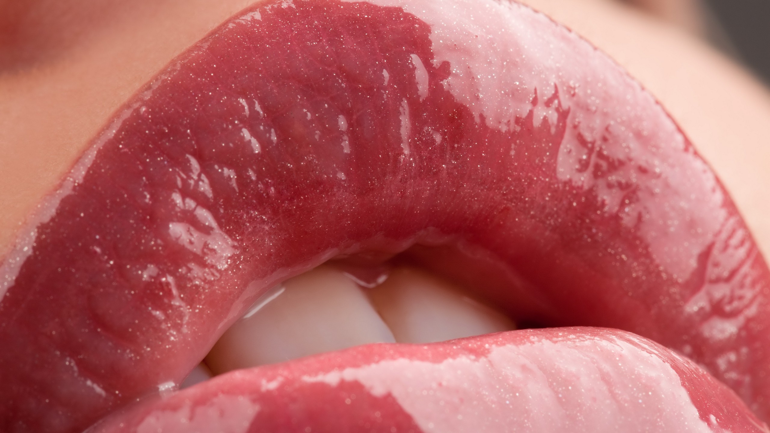 Close-up of glossy pink lips with teeth visible HD Wallpaper