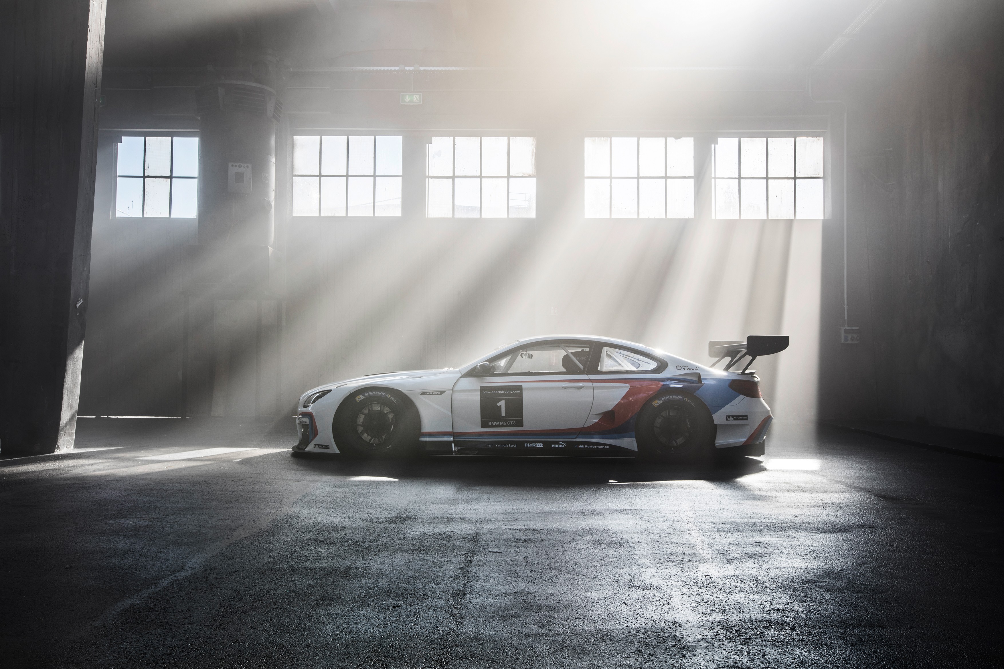 BMW M6 GT3 race car in a warehouse HD Wallpaper