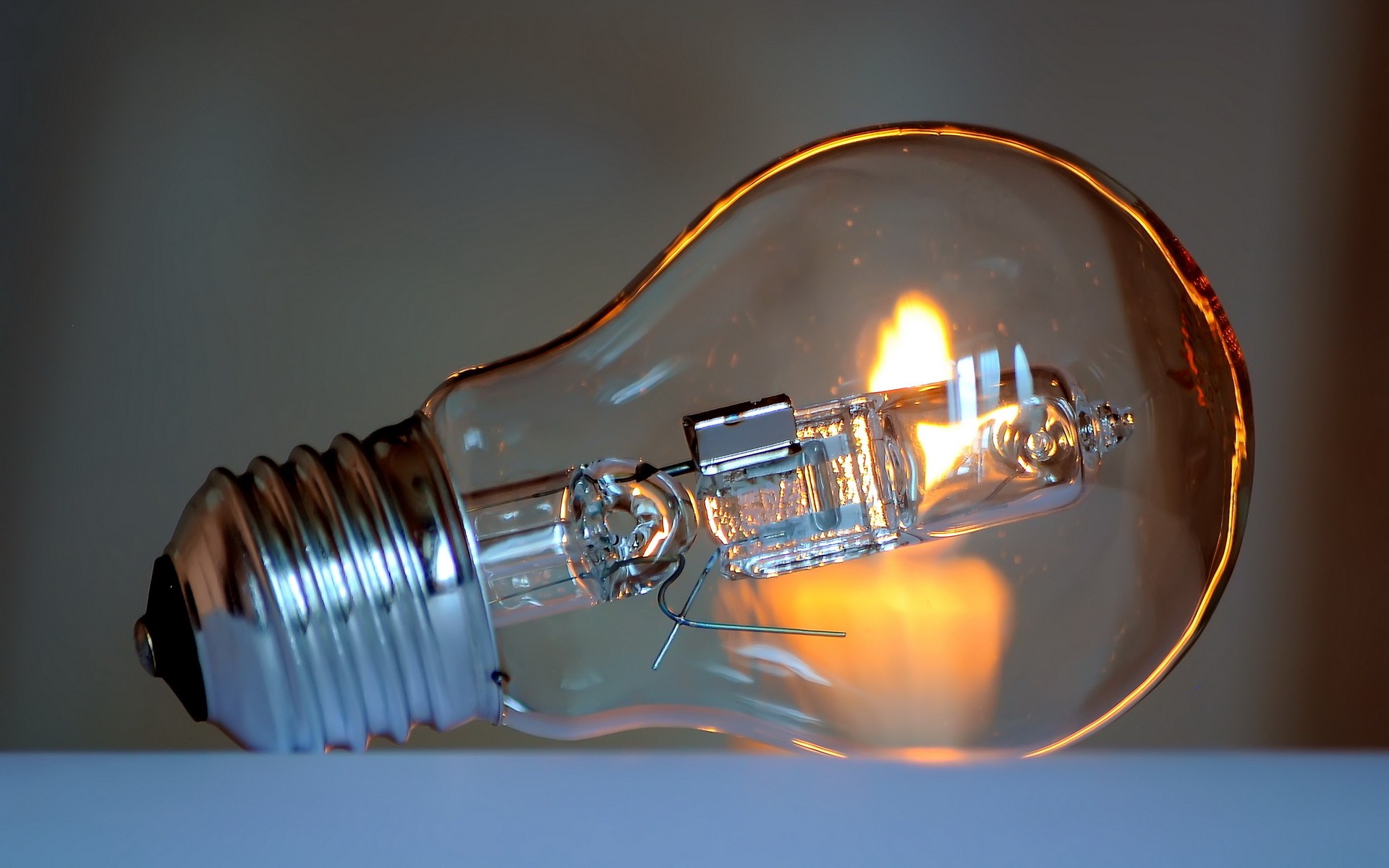 Close-up of a lit incandescent light bulb HD Wallpaper
