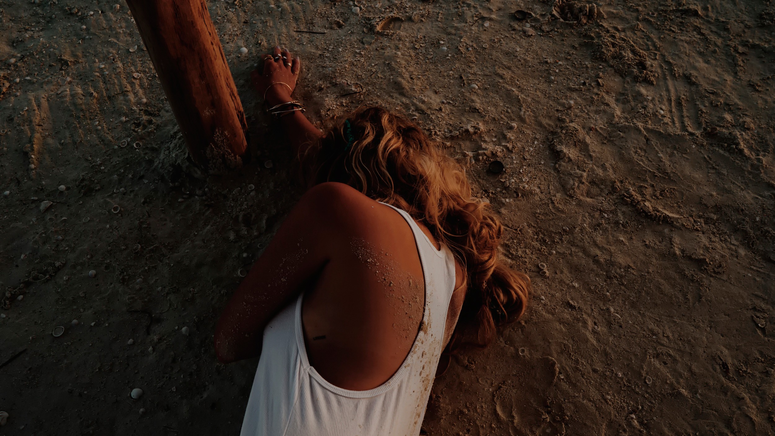 Ashley Benson lying on the sand HD Wallpaper