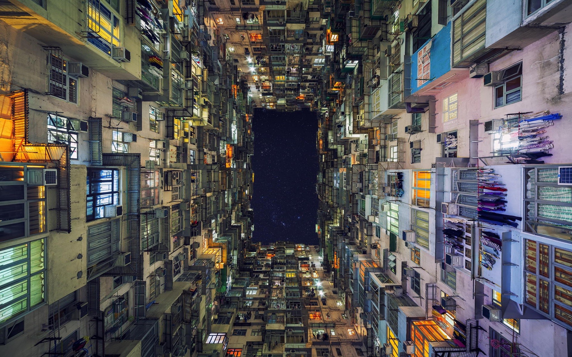 Hong Kong apartment buildings at night with stars visible HD Wallpaper