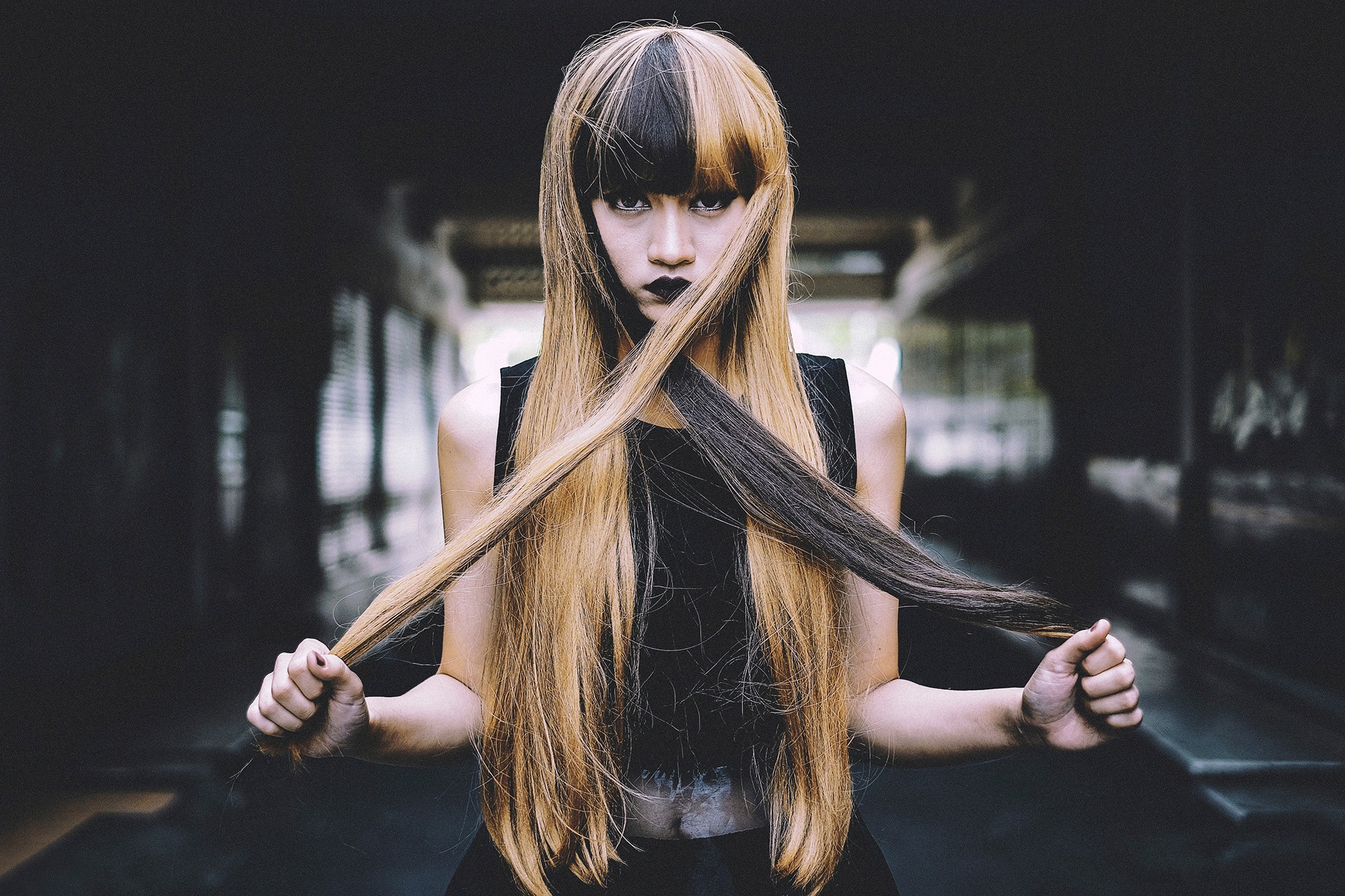 Woman with two-toned hair in a dark setting HD Wallpaper