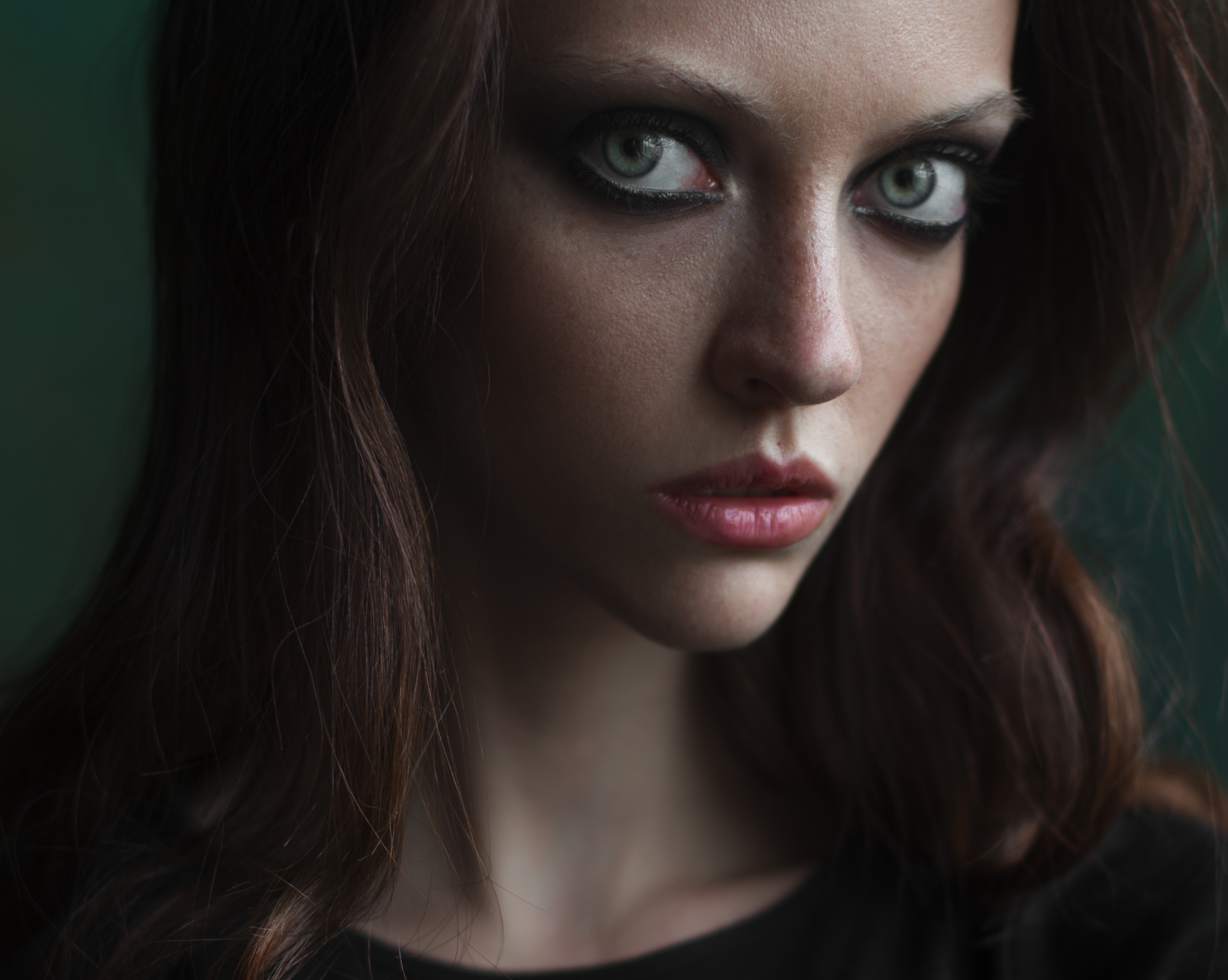 Portrait of a woman with dark hair and makeup HD Wallpaper