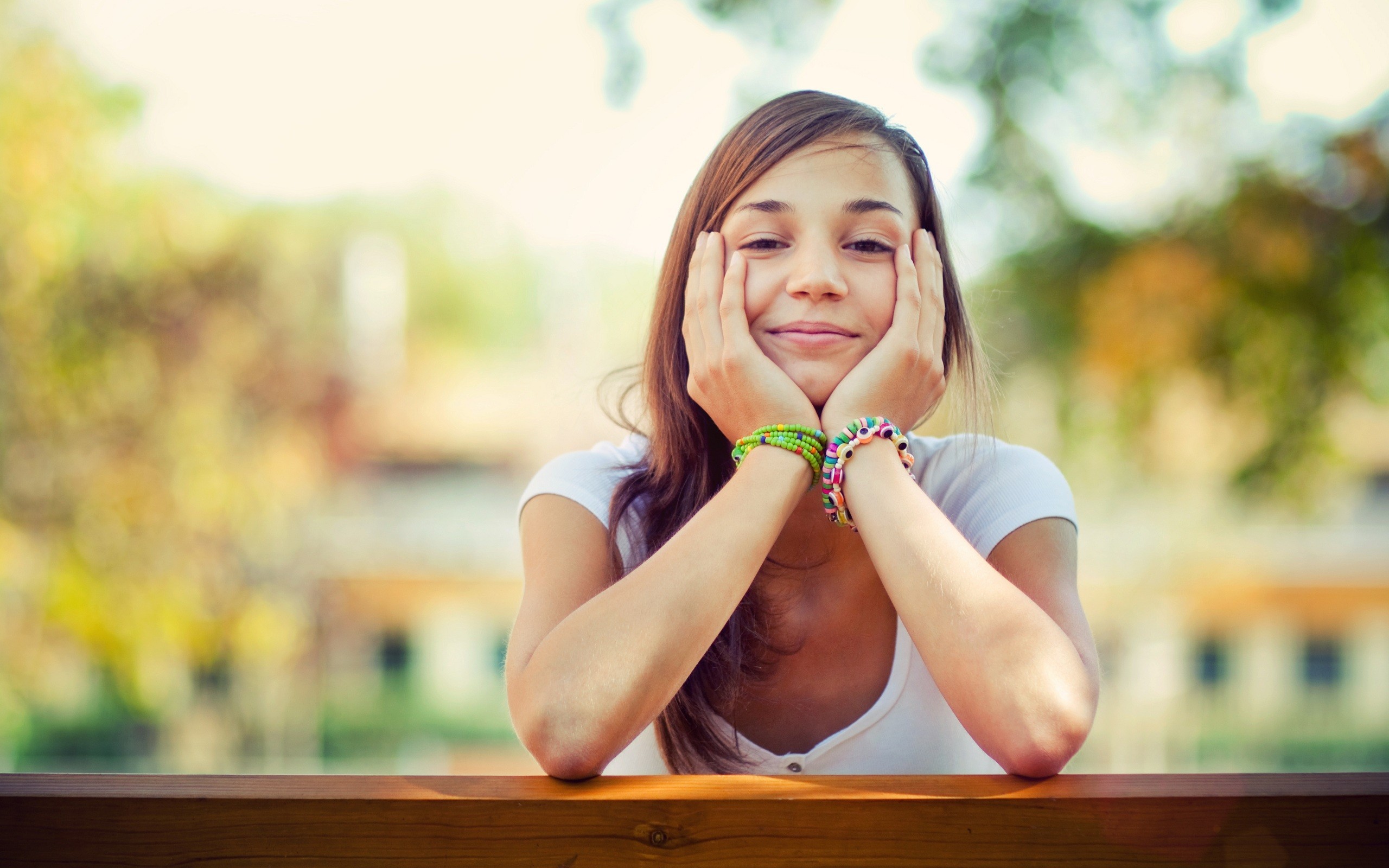 Young woman with hands on her cheeks HD Wallpaper
