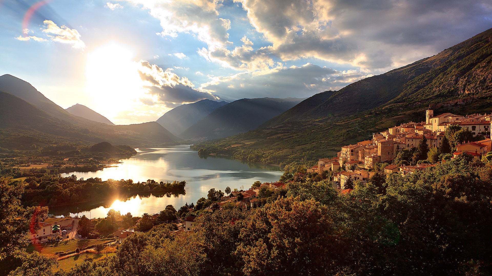 Town on a hill overlooking a lake in Italy HD Wallpaper
