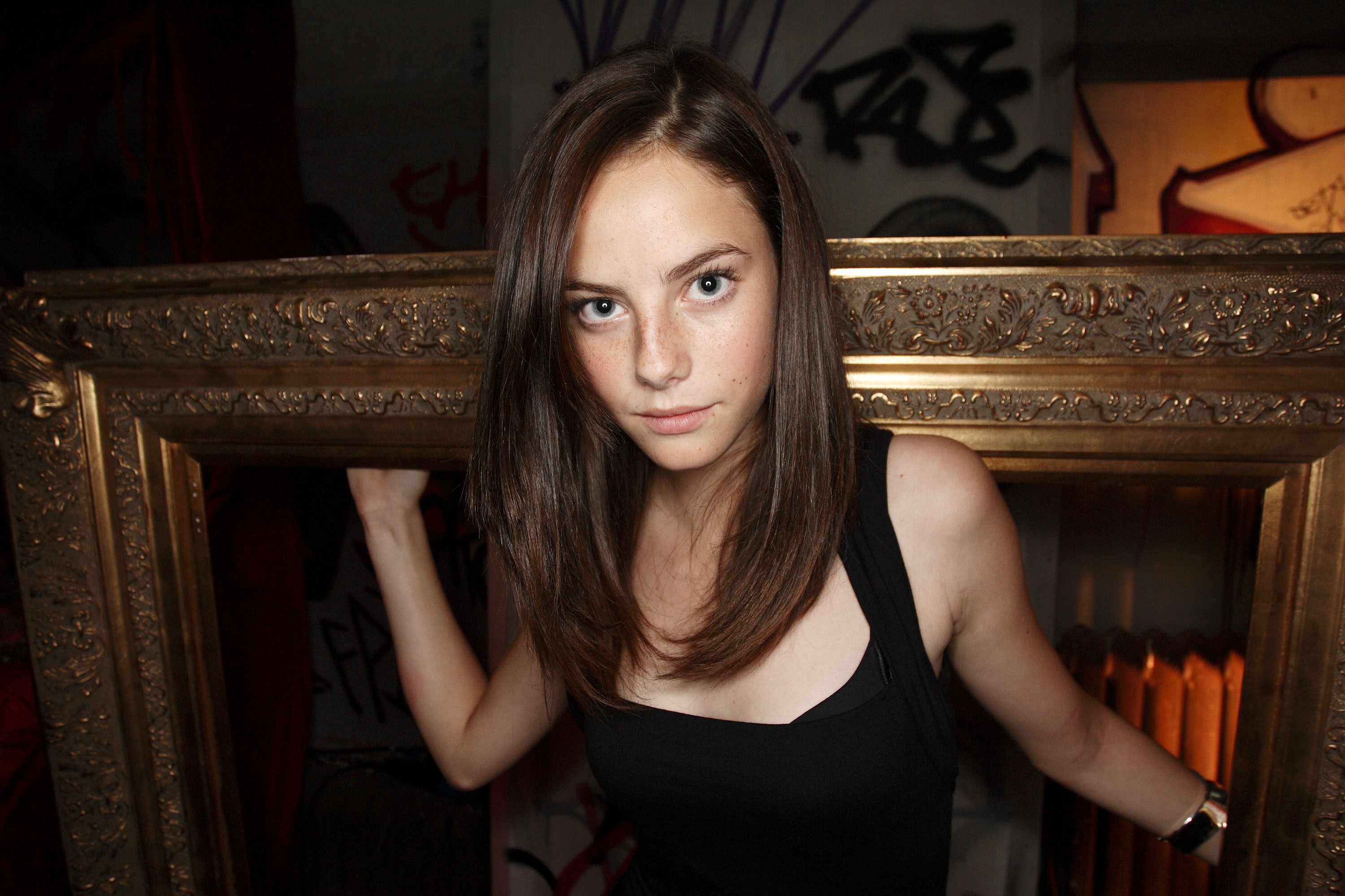 Kaya Scodelario framed by a golden ornate border HD Wallpaper