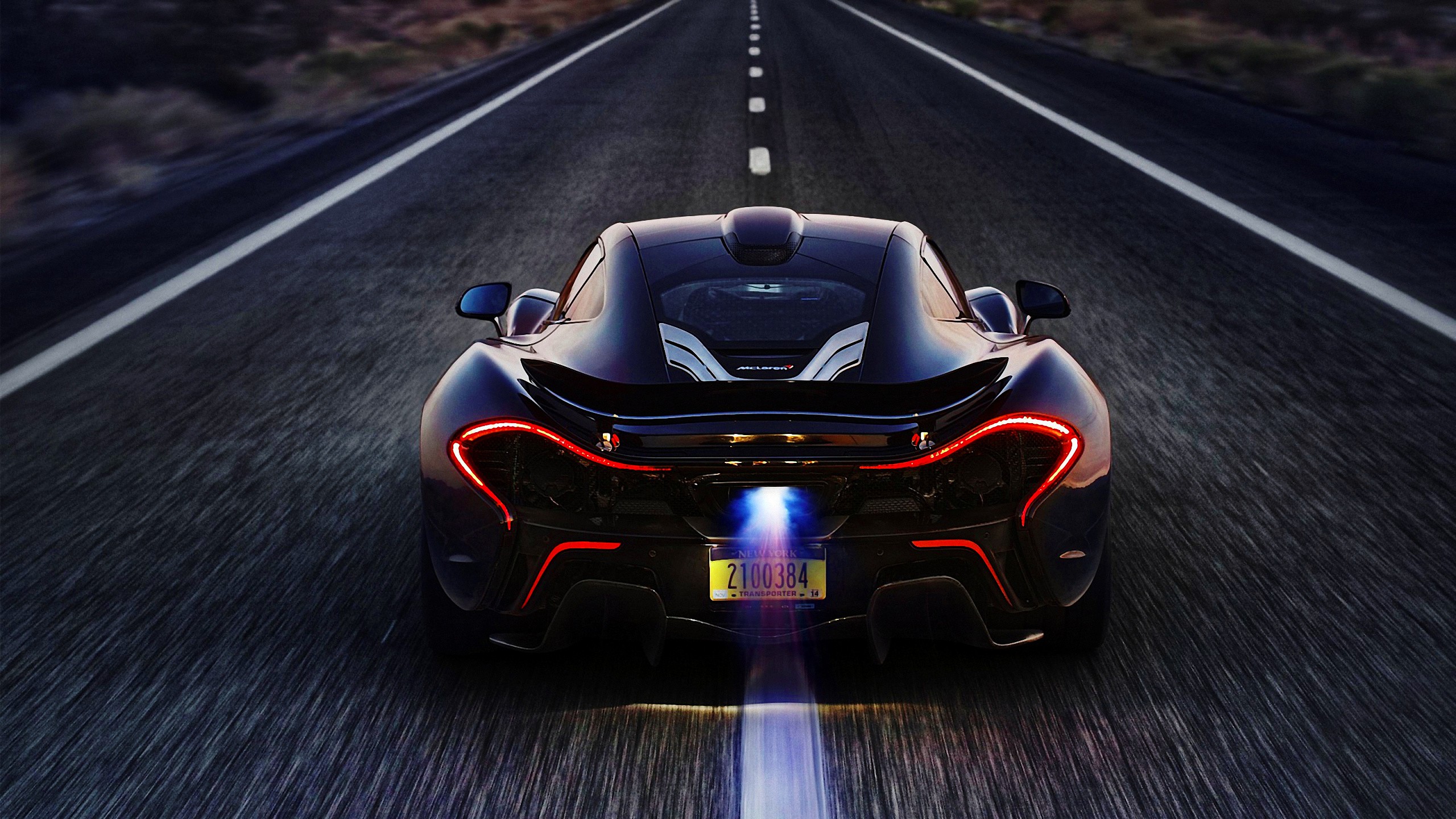 McLaren P1 driving on a road HD Wallpaper
