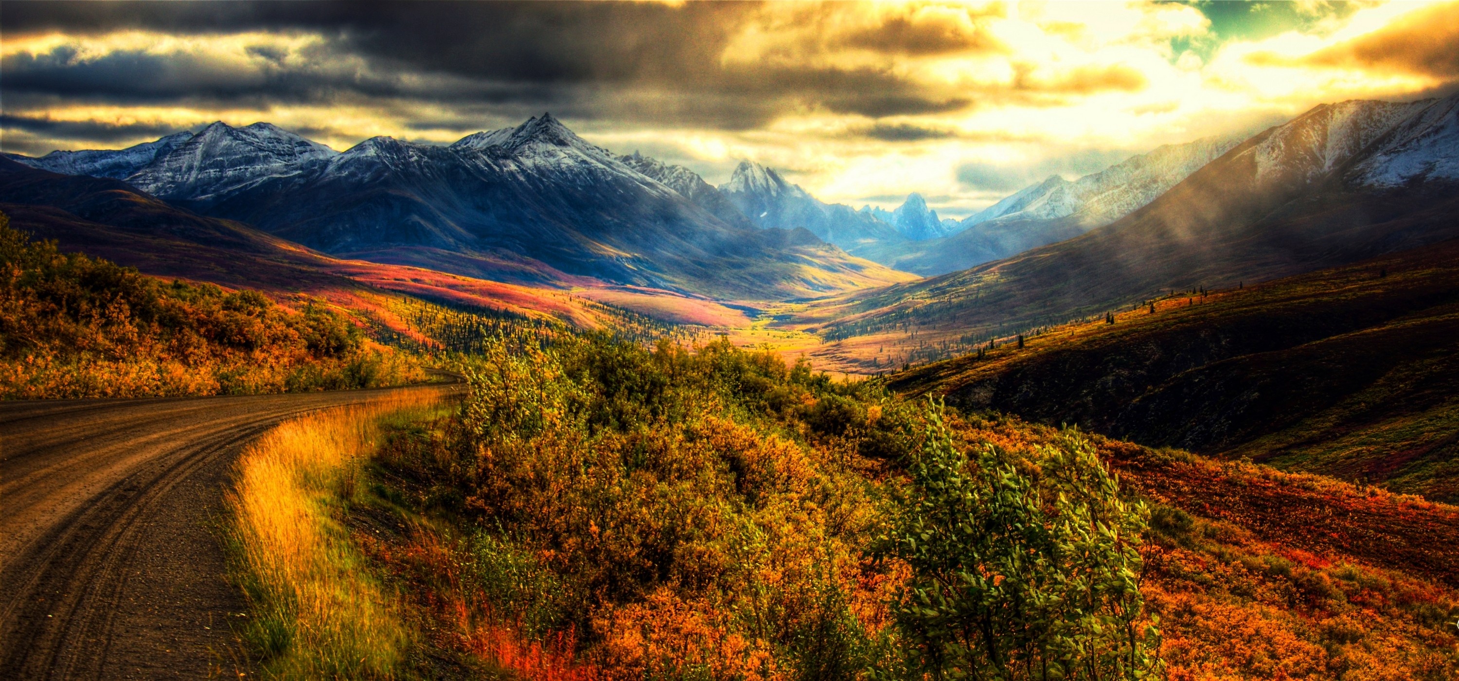 Autumn landscape with mountains and a dirt road HD Wallpaper