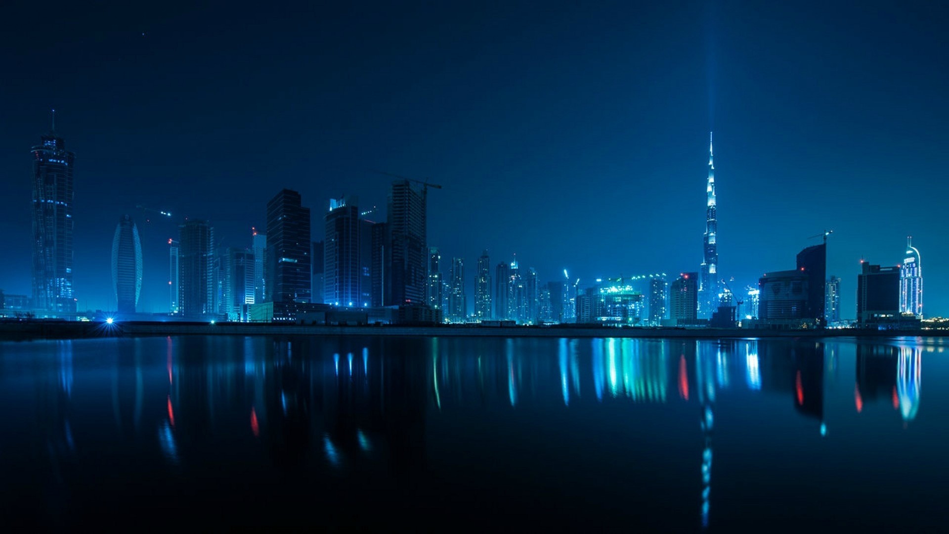Dubai skyline at night with reflections HD Wallpaper