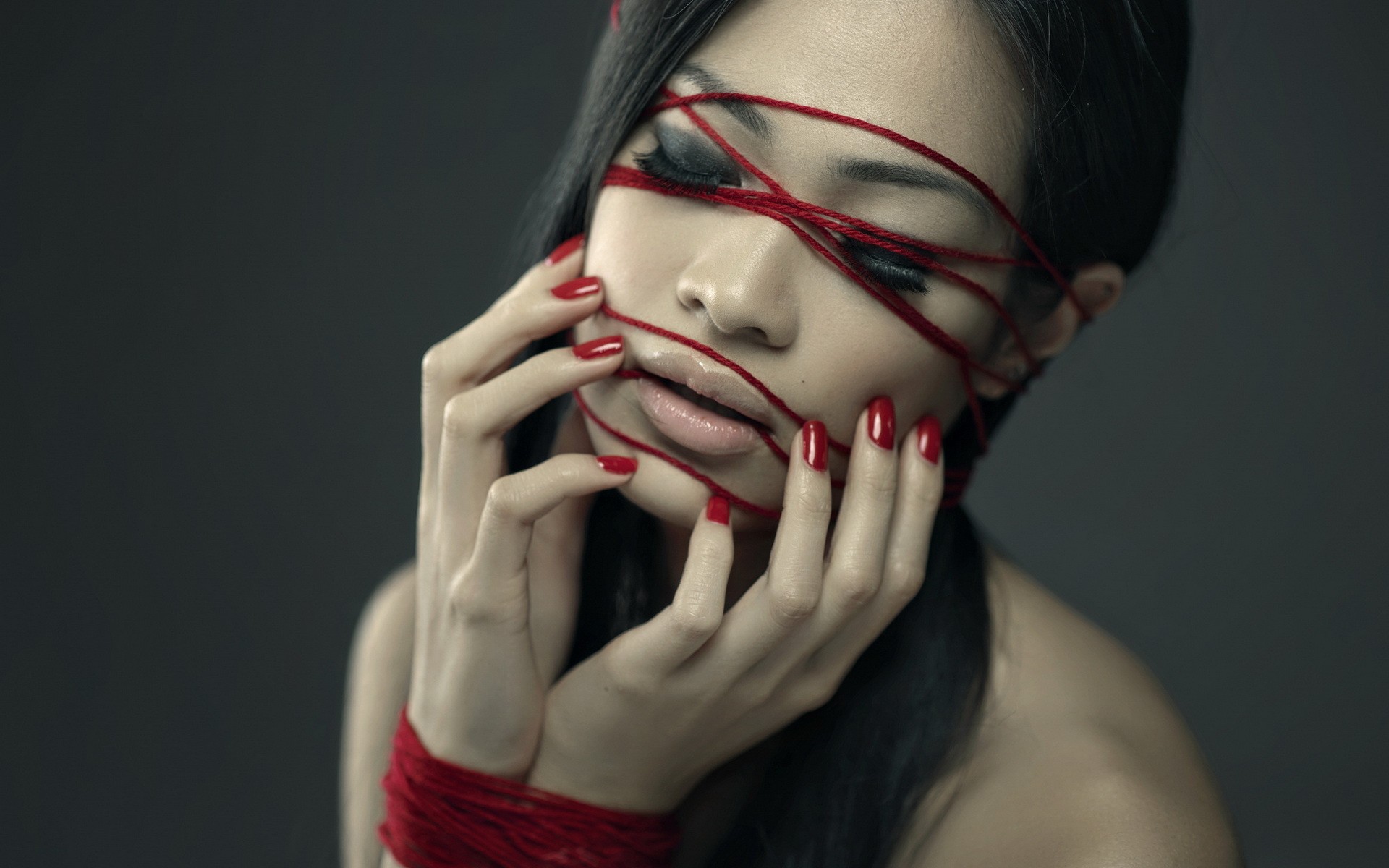 Woman with red string across her face HD Wallpaper