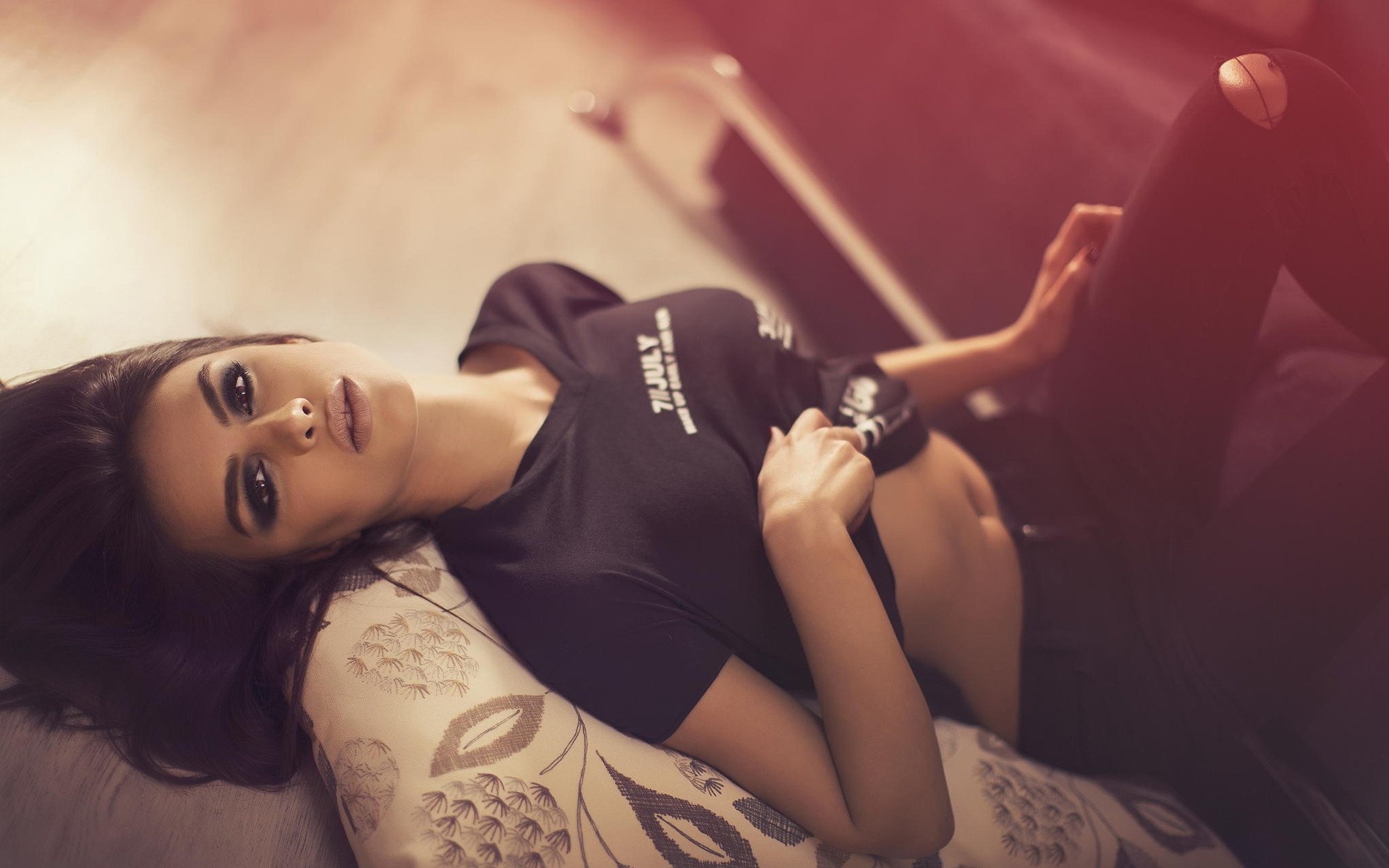 Woman in black shirt lying on pillow HD Wallpaper