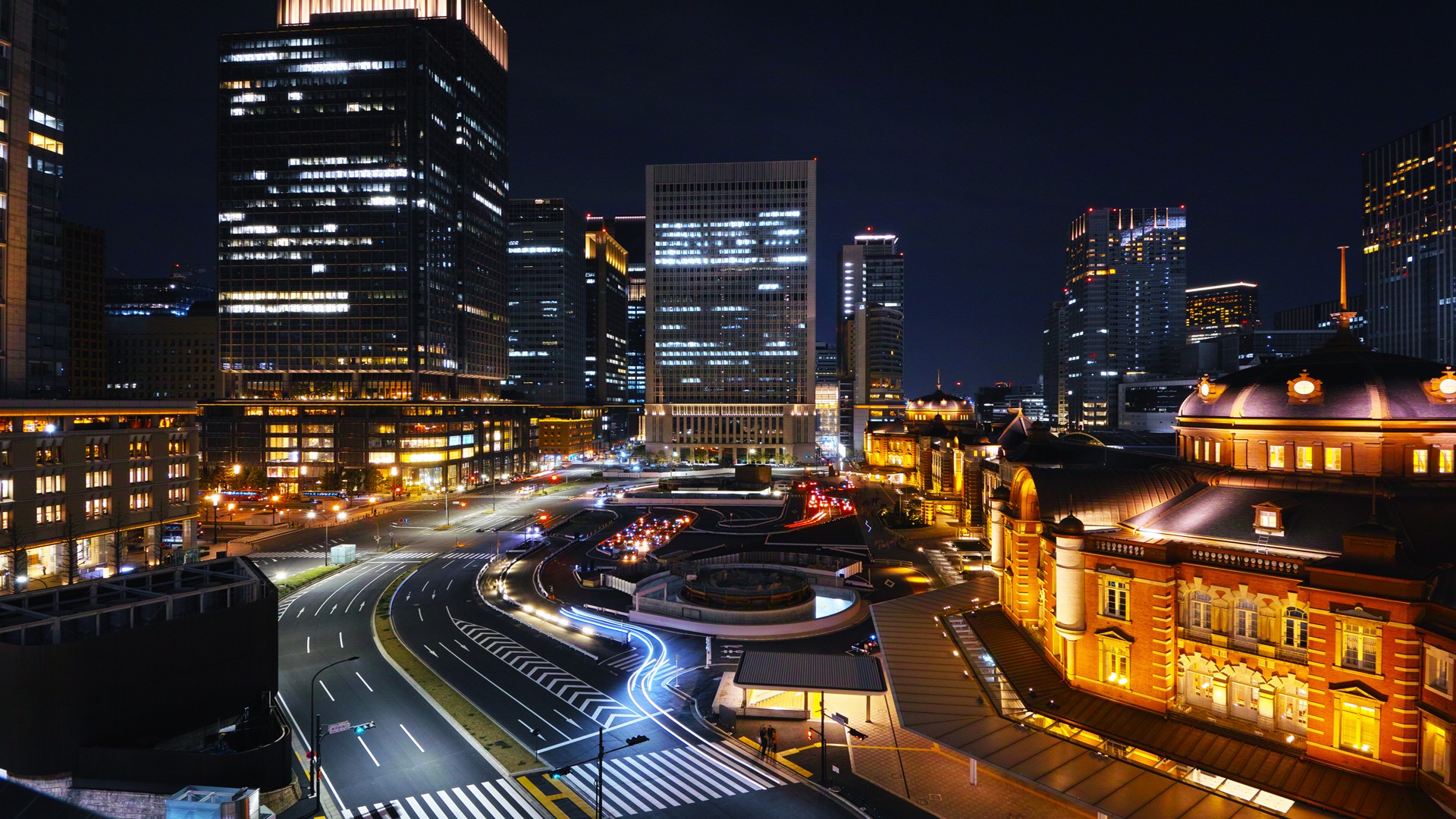 Tokyo Station at night with surrounding skyscrapers HD Wallpaper