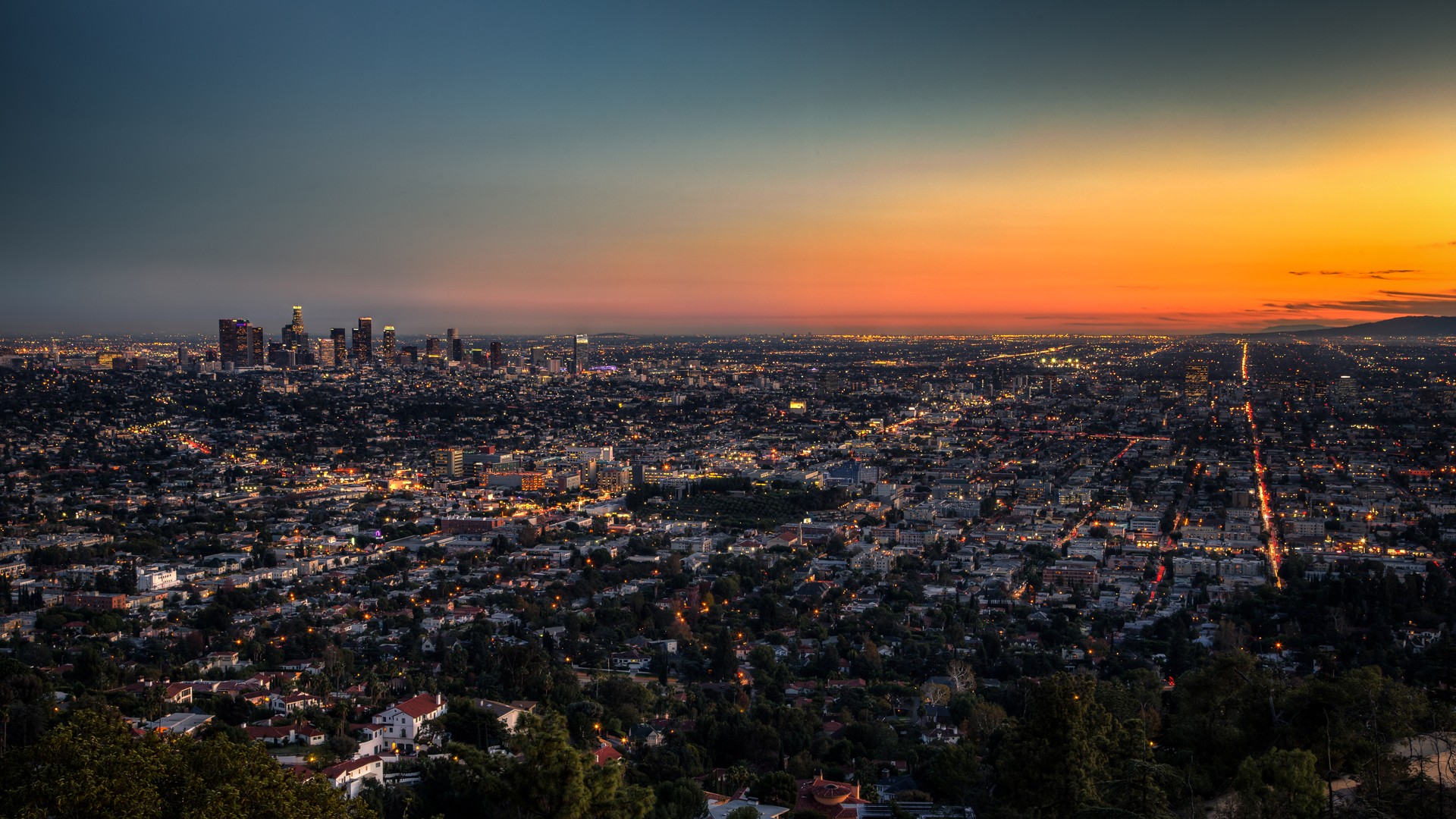 Los Angeles cityscape at dusk with a vibrant sunset HD Wallpaper