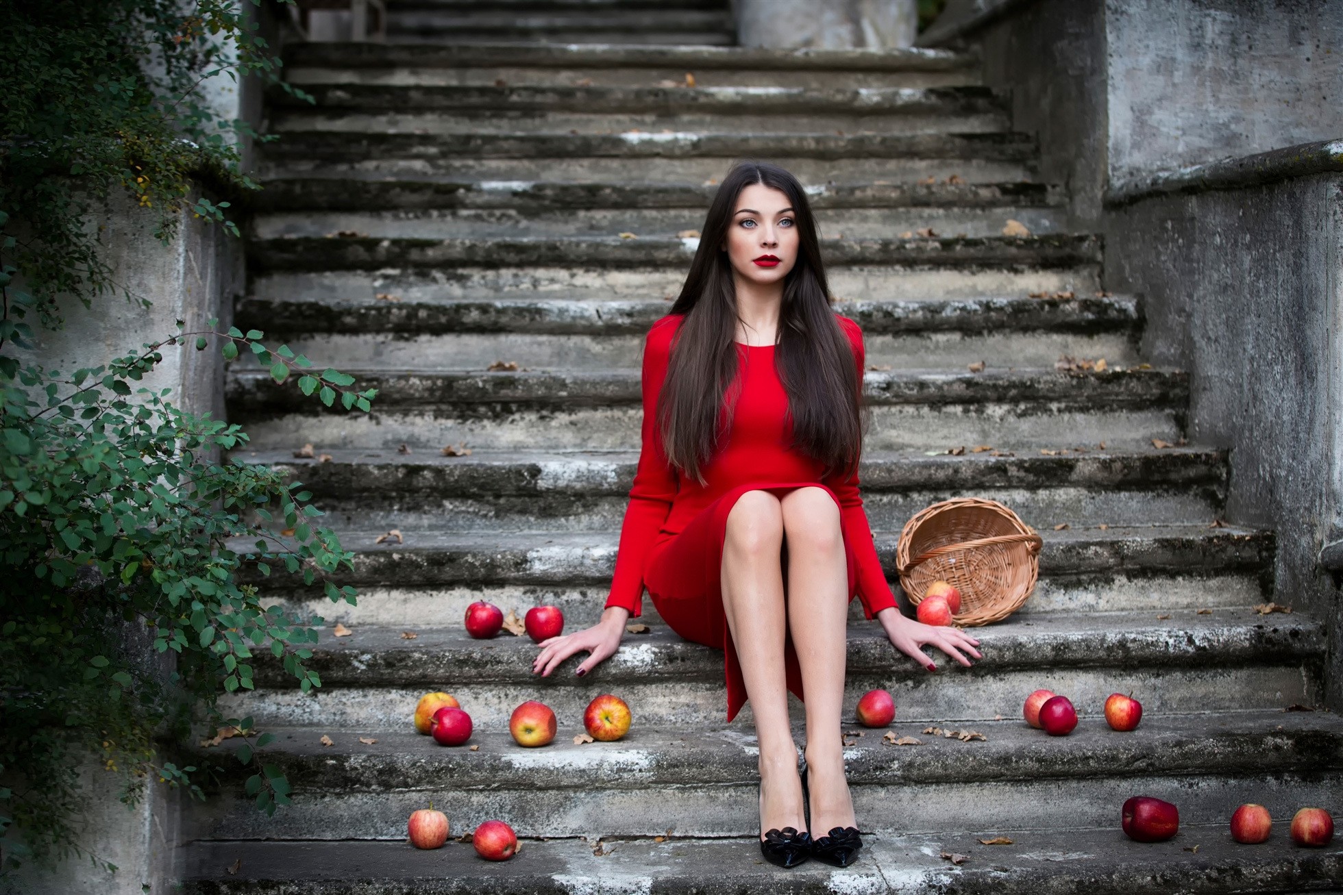 Woman in red dress sitting on stone stairs with apples HD Wallpaper