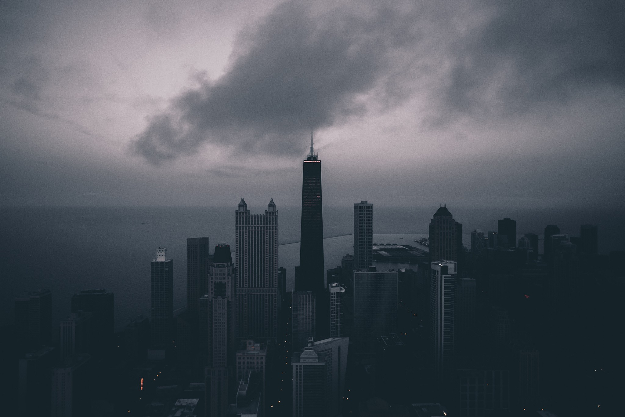 Cityscape with tall buildings under cloudy sky HD Wallpaper